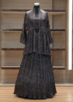 Dark patterned dress on a mannequin against a wooden panel background