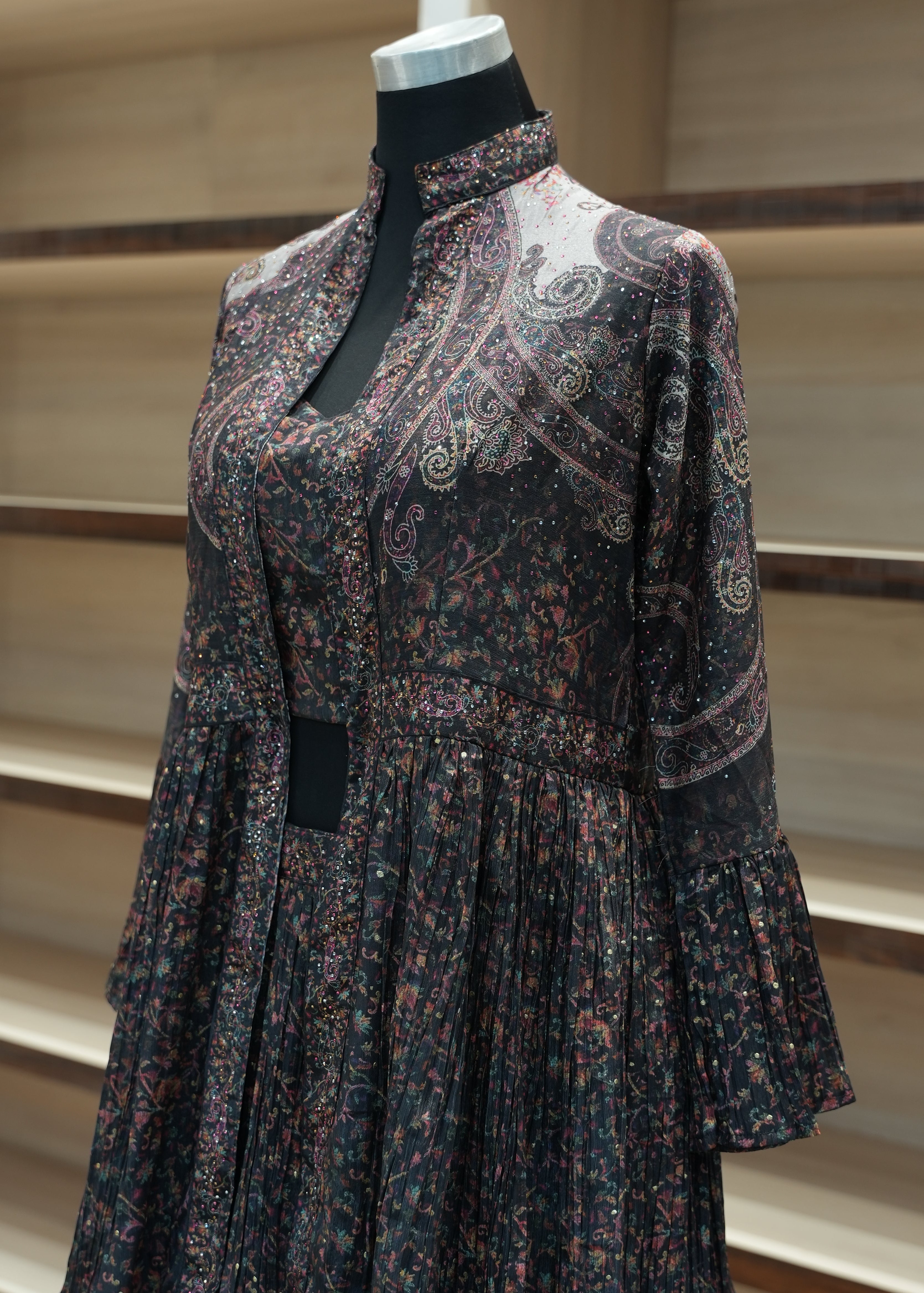 Patterned dress on a mannequin against a neutral background
