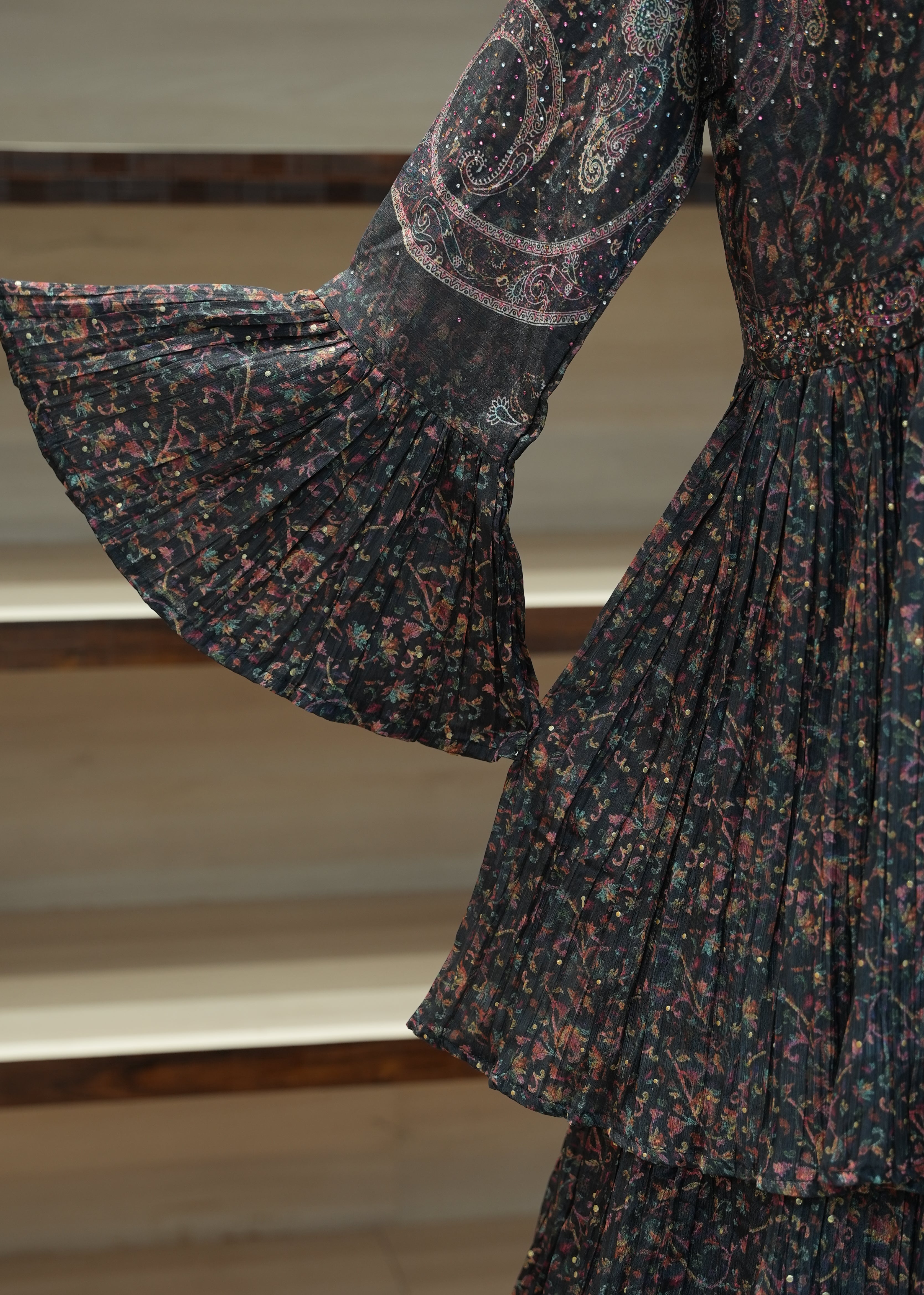 Floral patterned fabric being held up against a neutral background