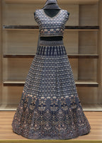 Traditional outfit with a patterned top and skirt on a wooden shelf.