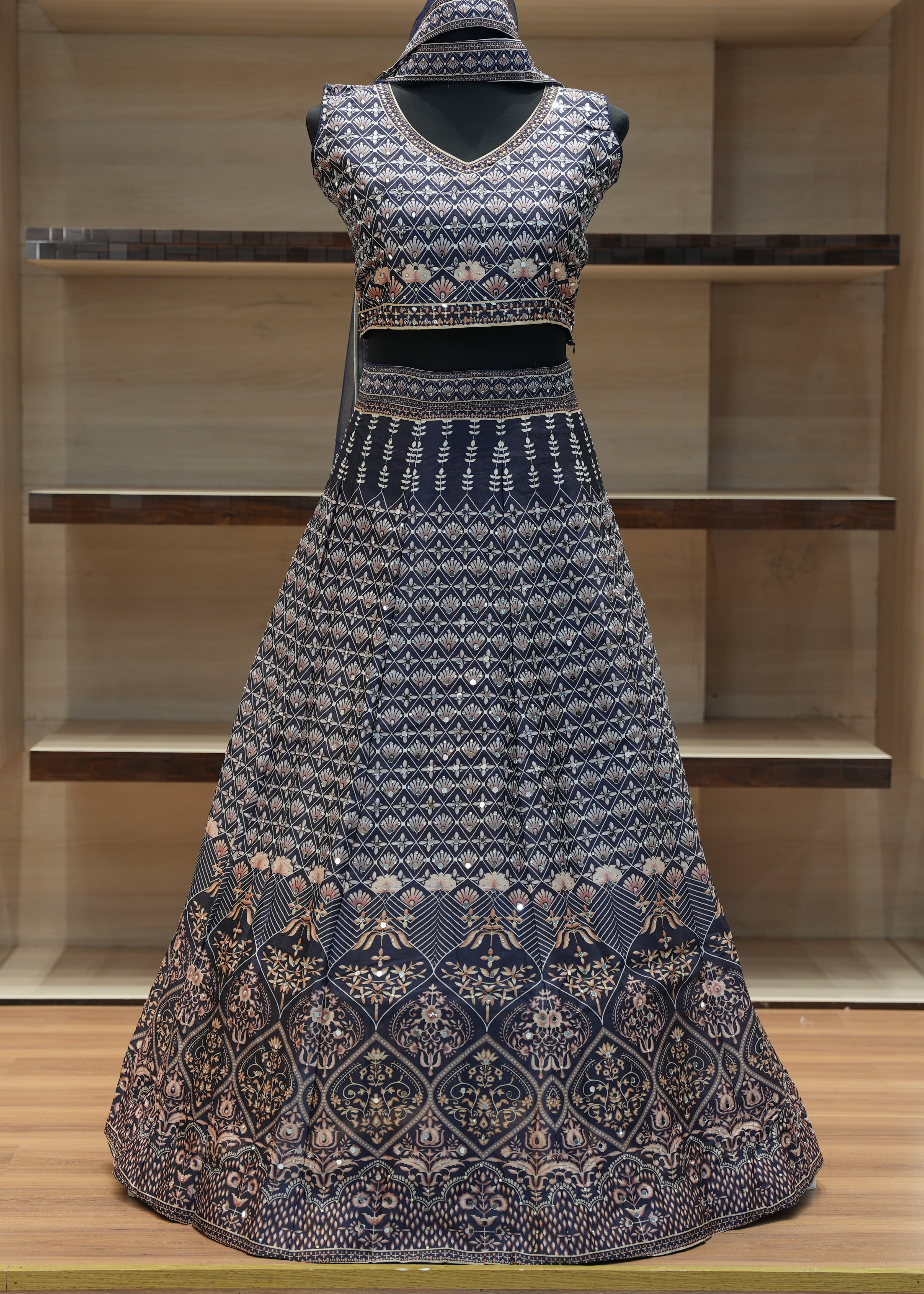 Traditional outfit with a patterned top and skirt on a wooden shelf.