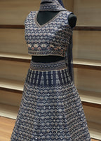 Traditional embroidered garment on a wooden stand with a neutral background