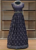 Navy blue dress with white floral pattern on a mannequin against a wooden panel background