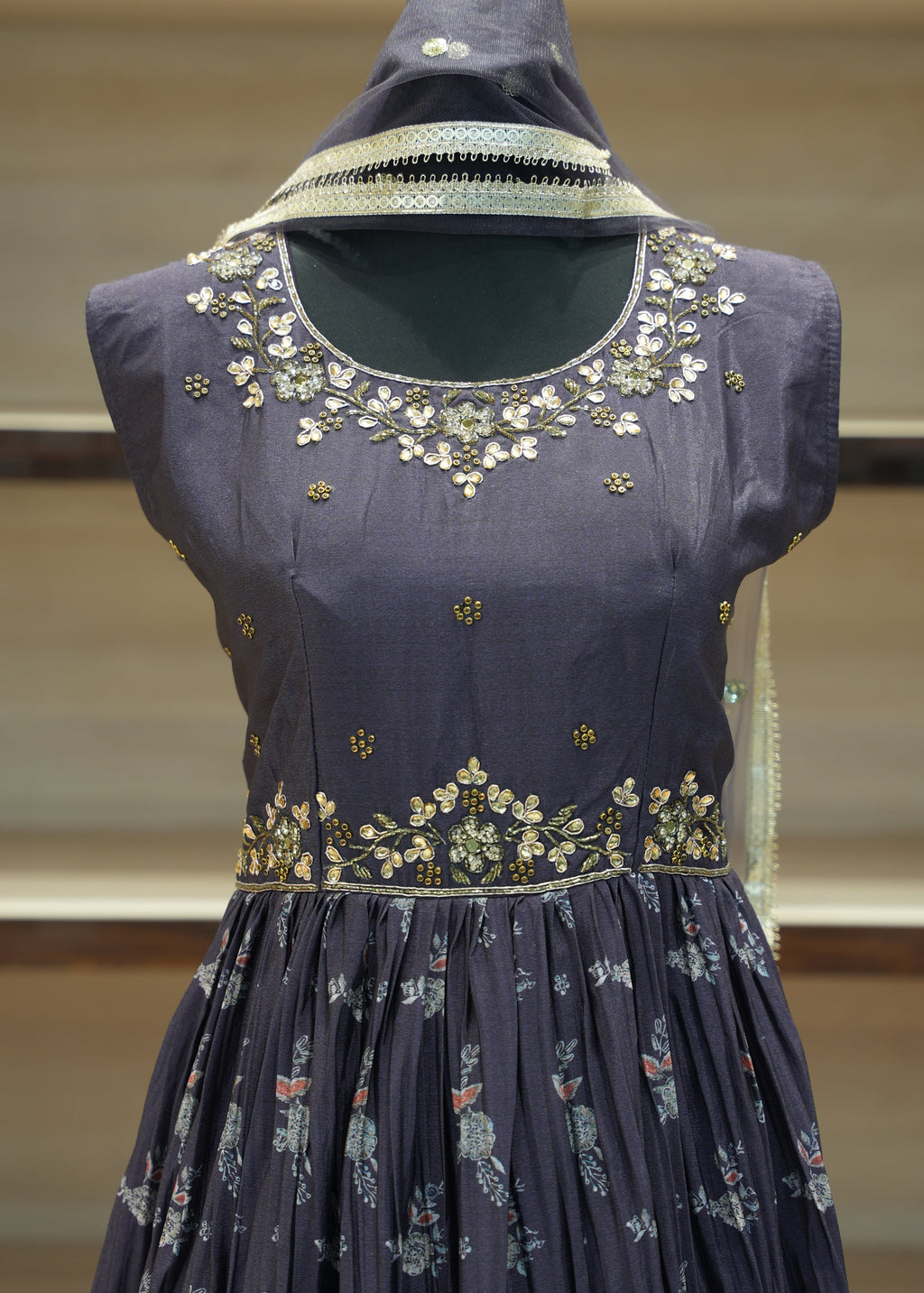 Navy blue embroidered blouse on a mannequin with a blurred background
