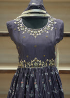 Navy blue embroidered blouse on a mannequin with a blurred background