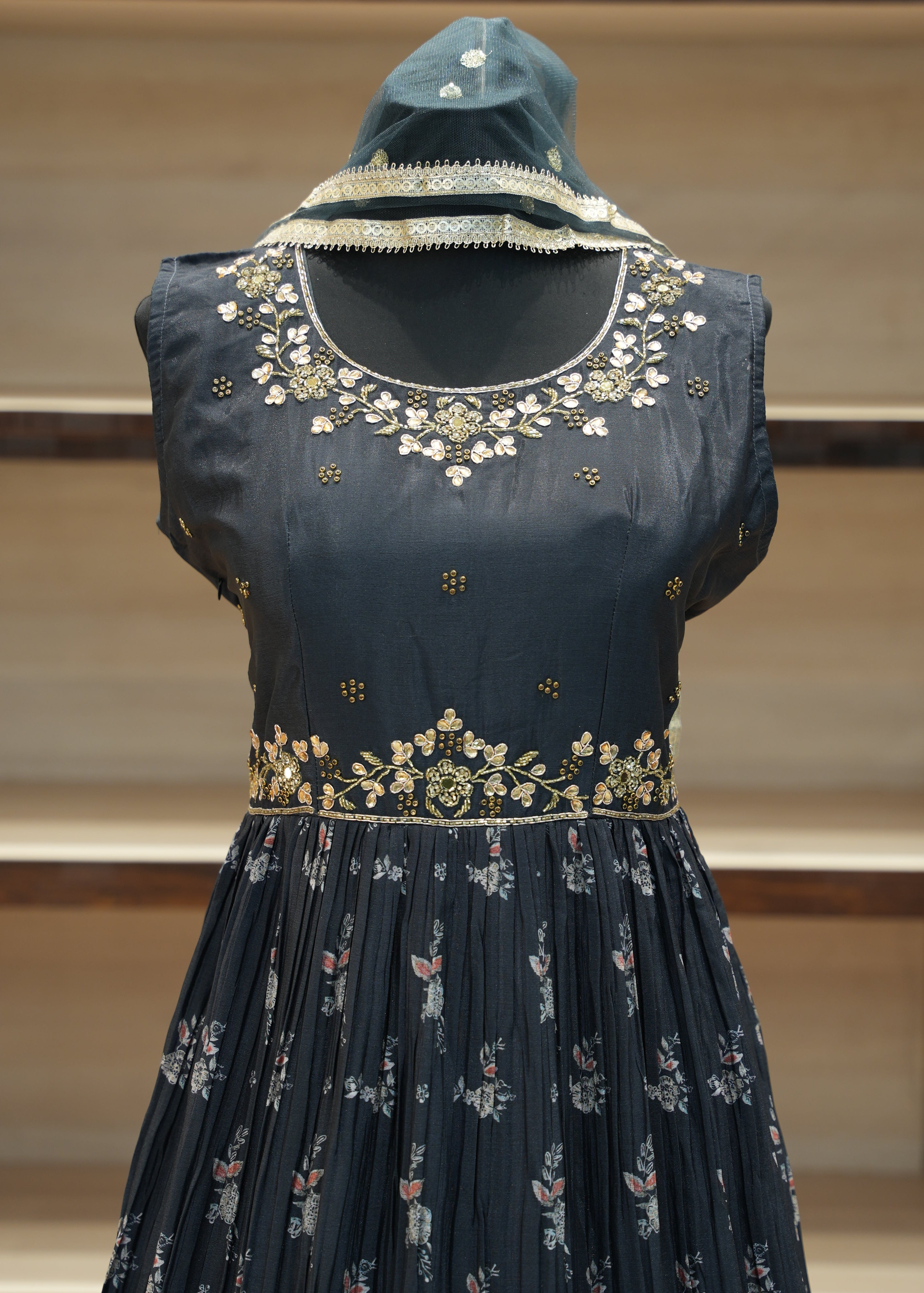 Black embroidered blouse on a mannequin against a neutral background