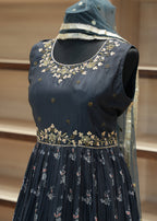 Navy blue embroidered blouse on a mannequin with a neutral background