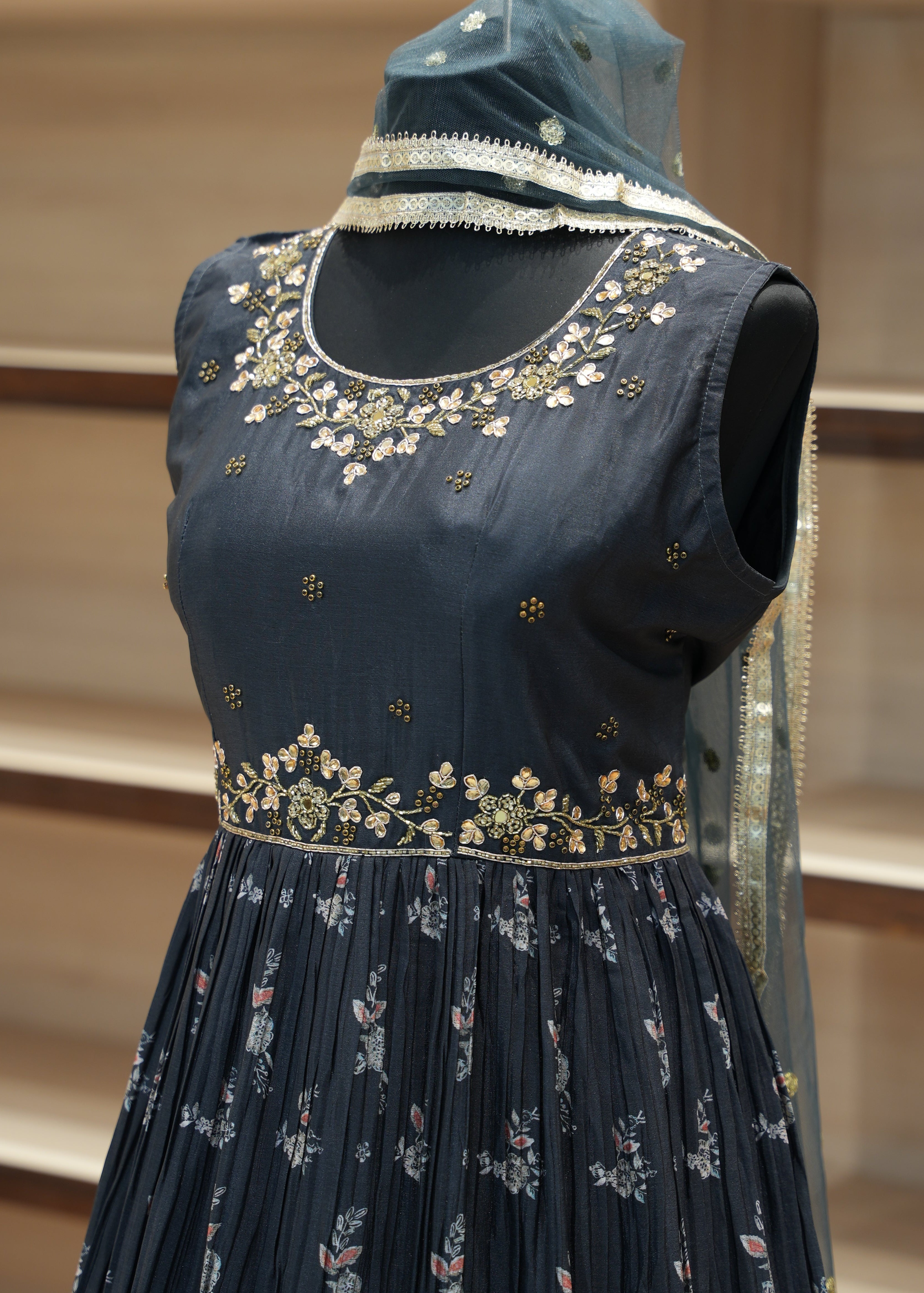 Navy blue embroidered blouse on a mannequin with a neutral background
