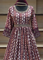 Patterned dress with a hood on a mannequin against a neutral background