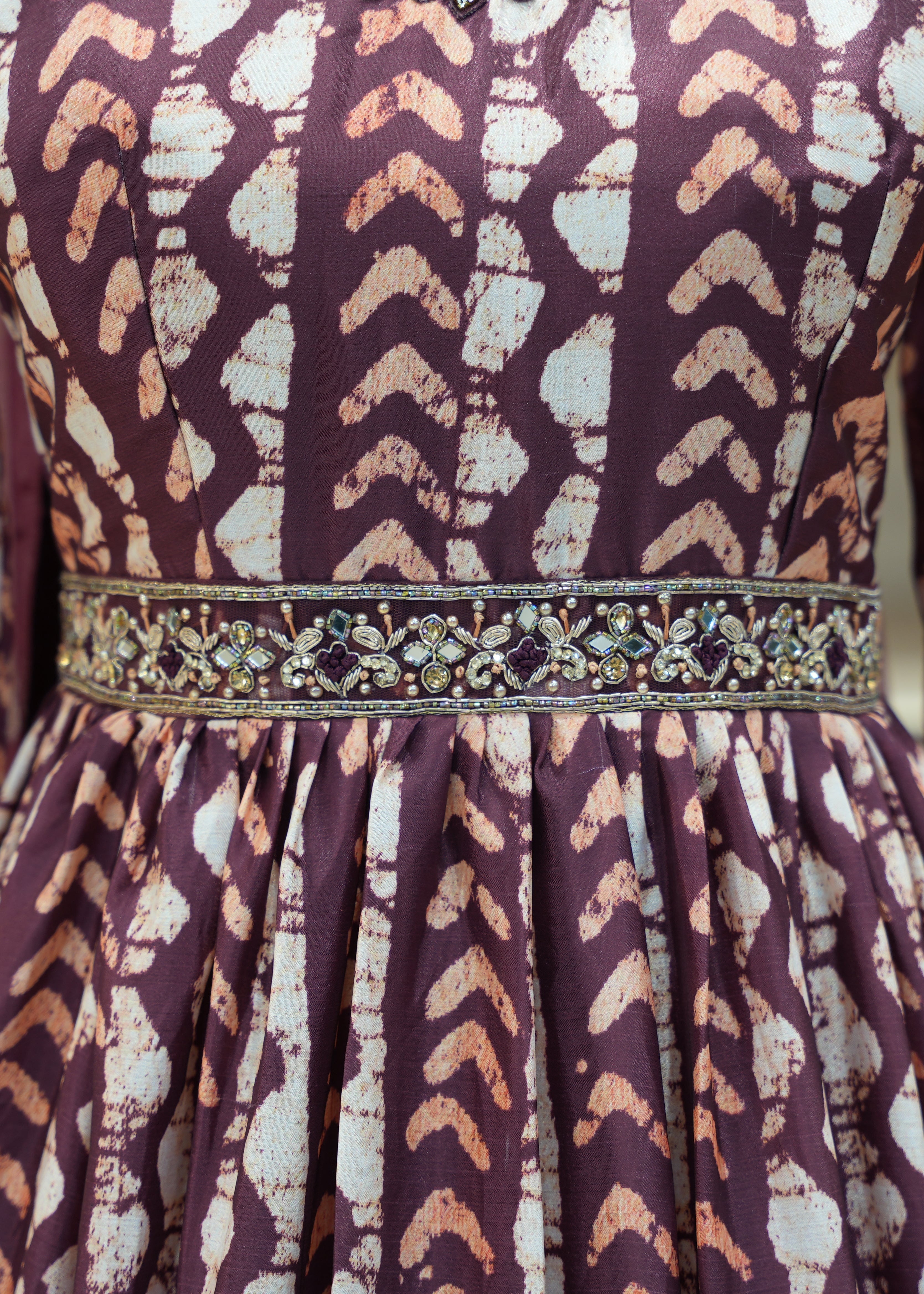 Patterned dress with a decorative belt on a mannequin