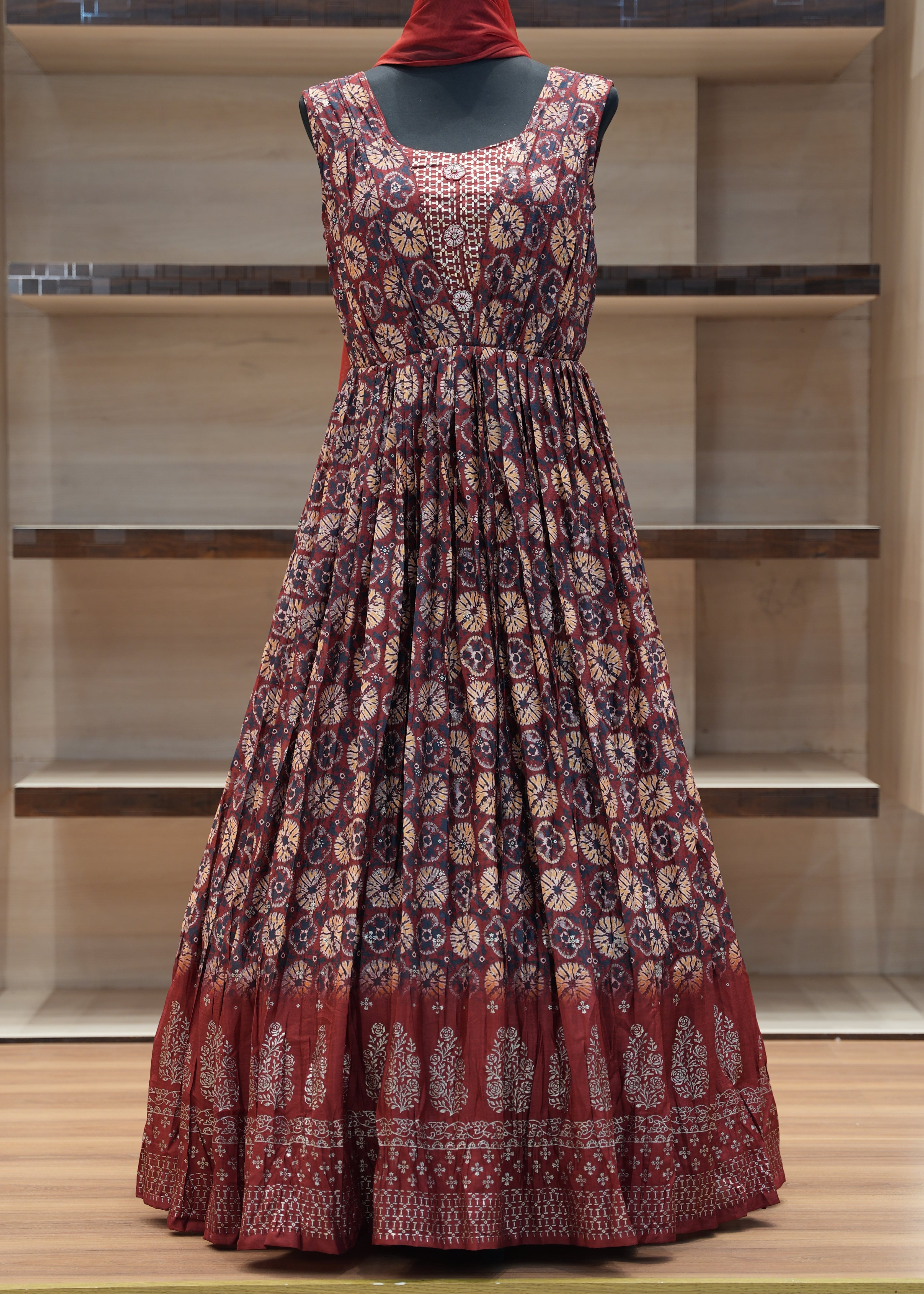 Red floral dress on a mannequin against a neutral background