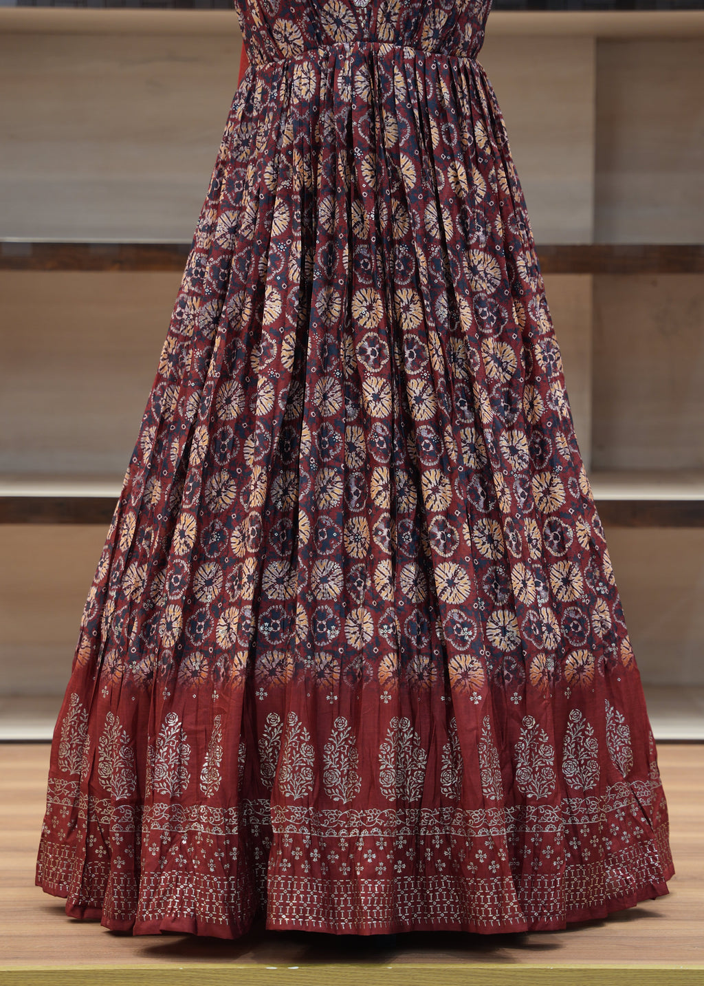 Red patterned fabric draped over a chair with a neutral background