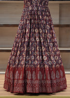 Red patterned fabric draped over a chair with a neutral background