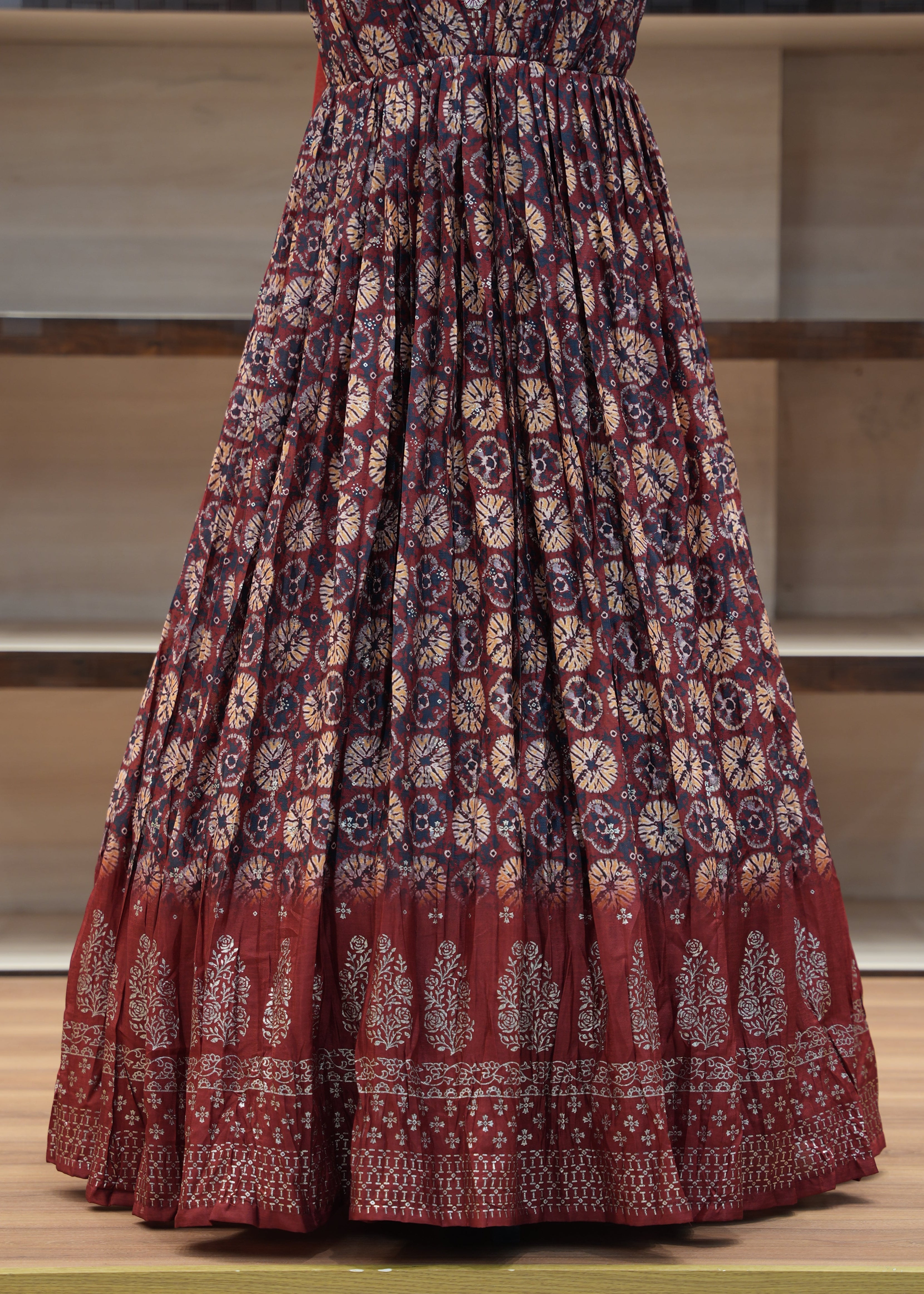 Red patterned fabric draped over a chair with a neutral background