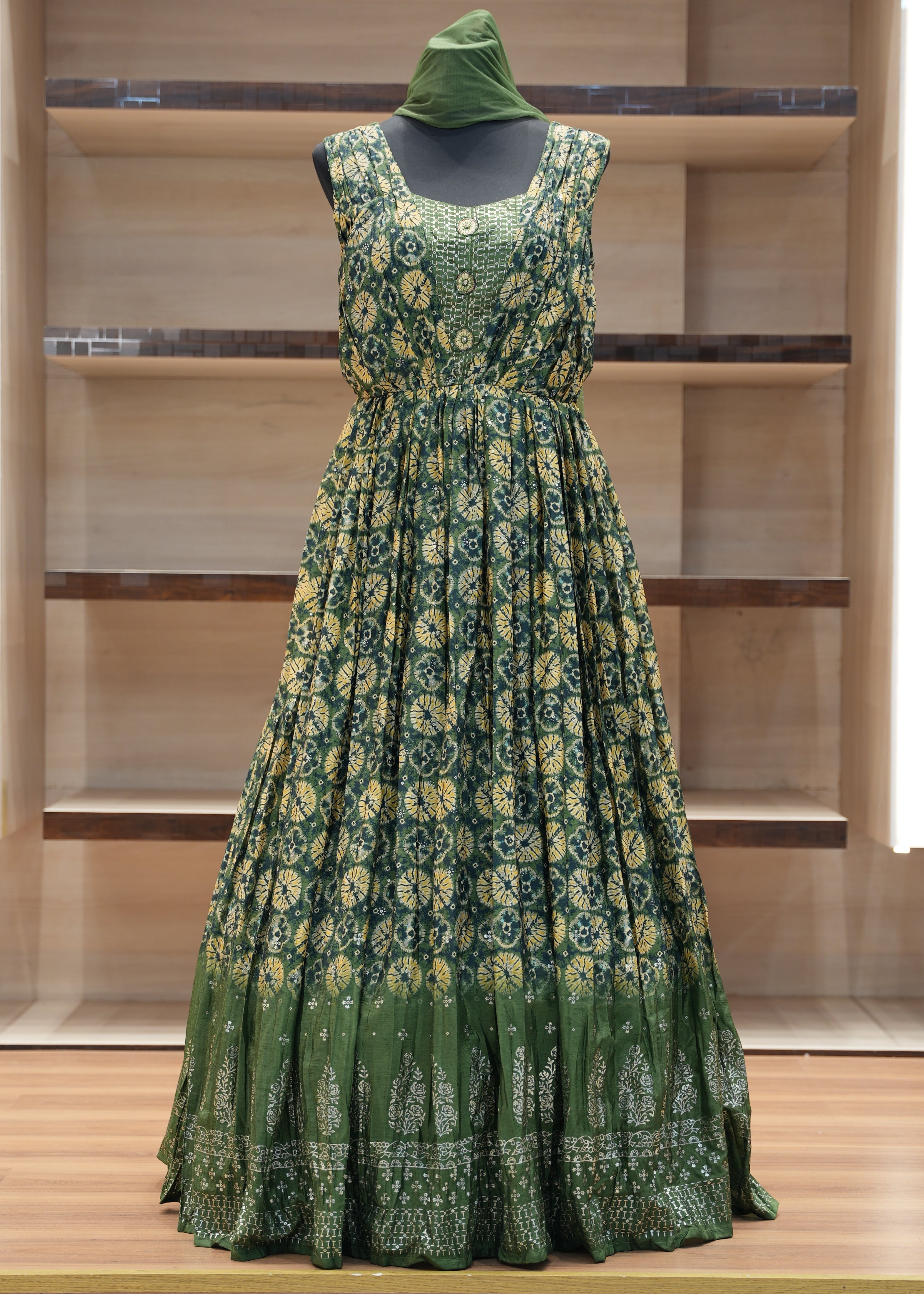 Green floral dress on a mannequin against a wooden panel background