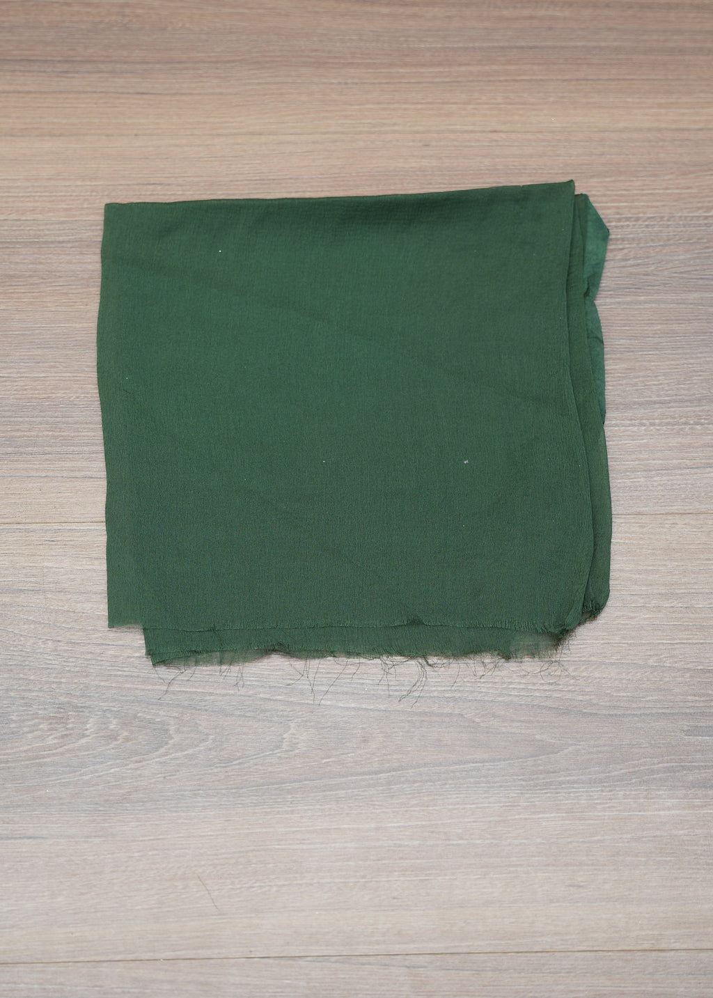 Green fabric on a wooden surface
