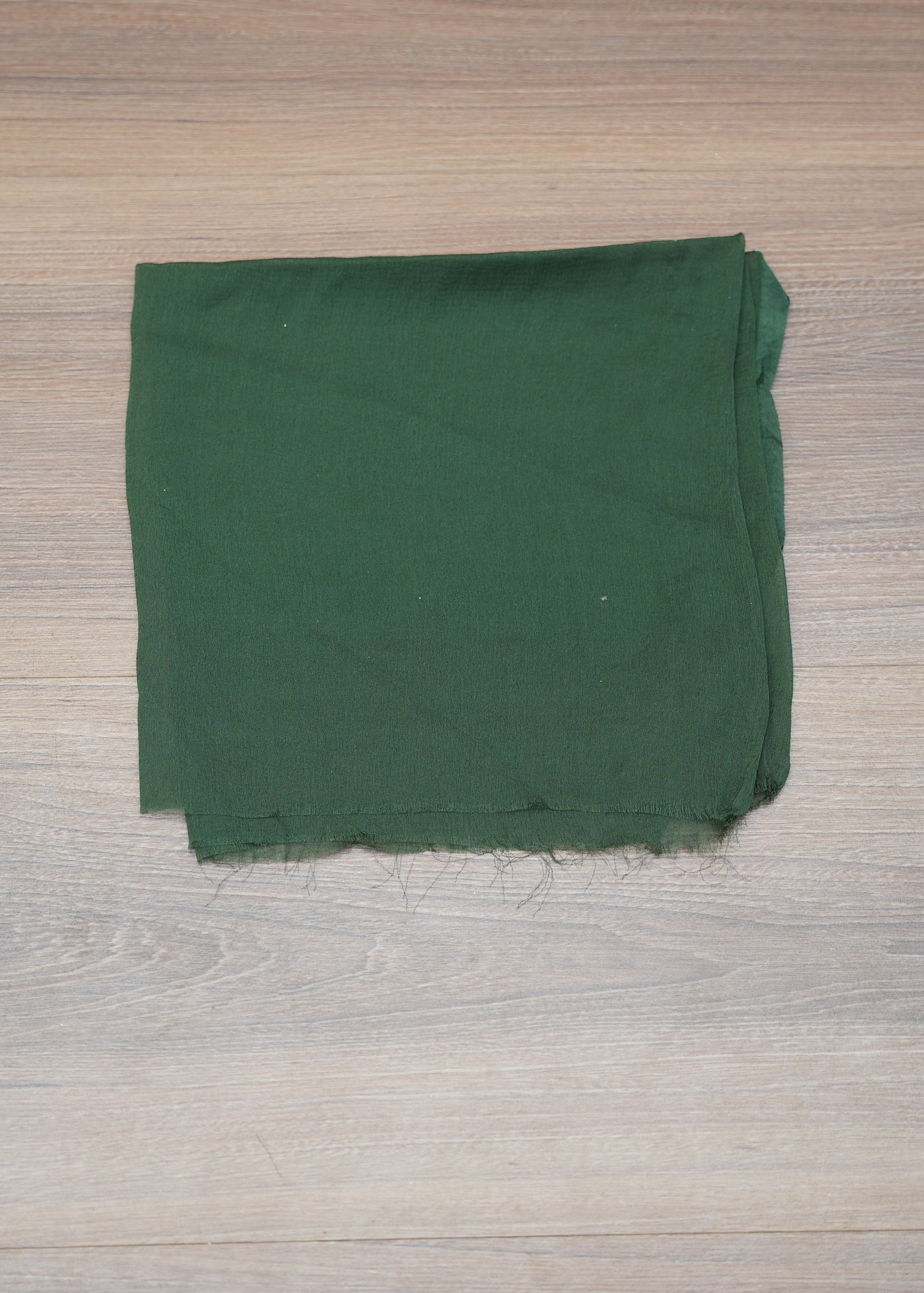 Green fabric on a wooden surface