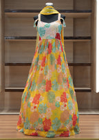 Colorful floral dress on a mannequin against a wooden background