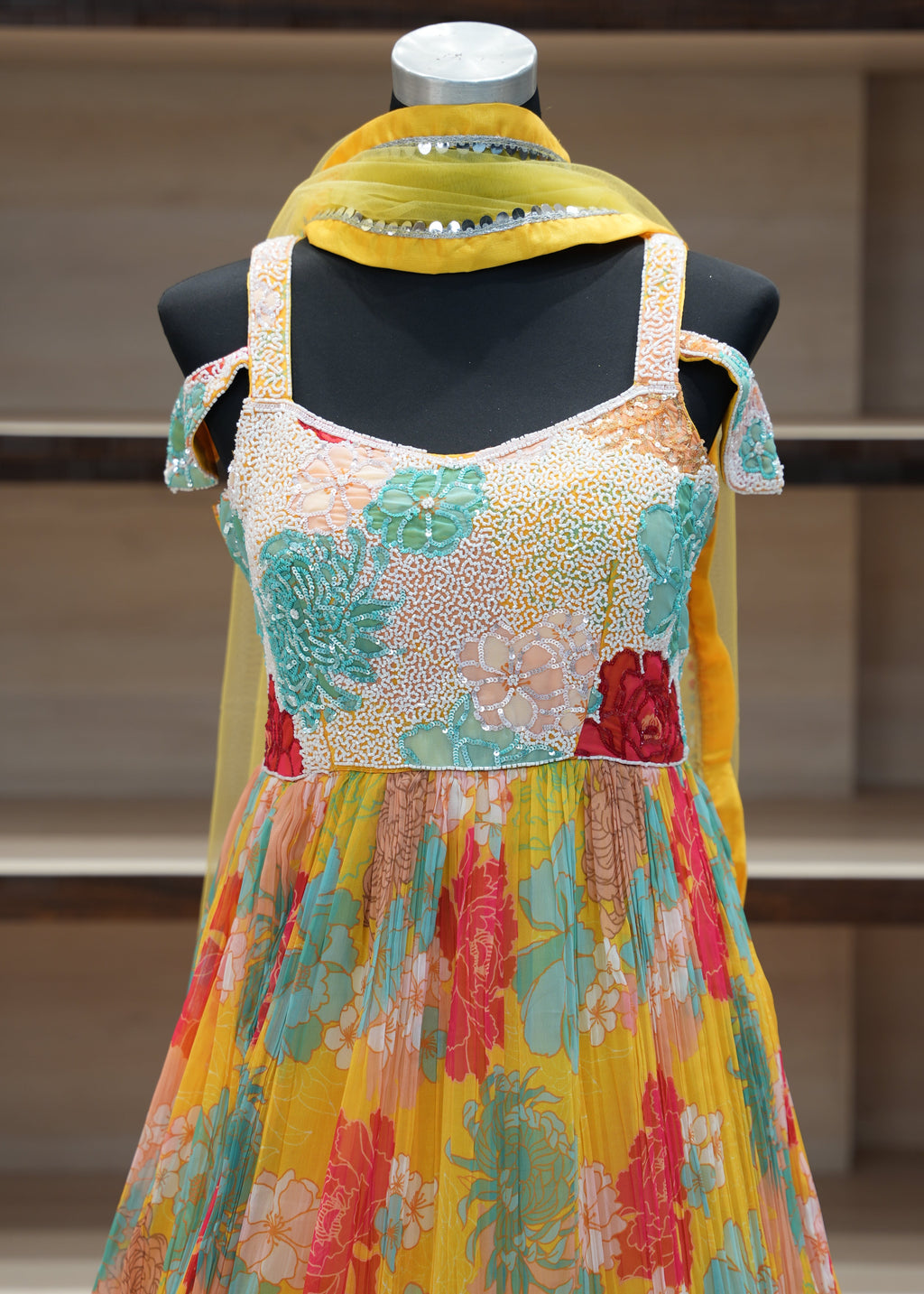 Colorful floral dress on a mannequin with a blurred background