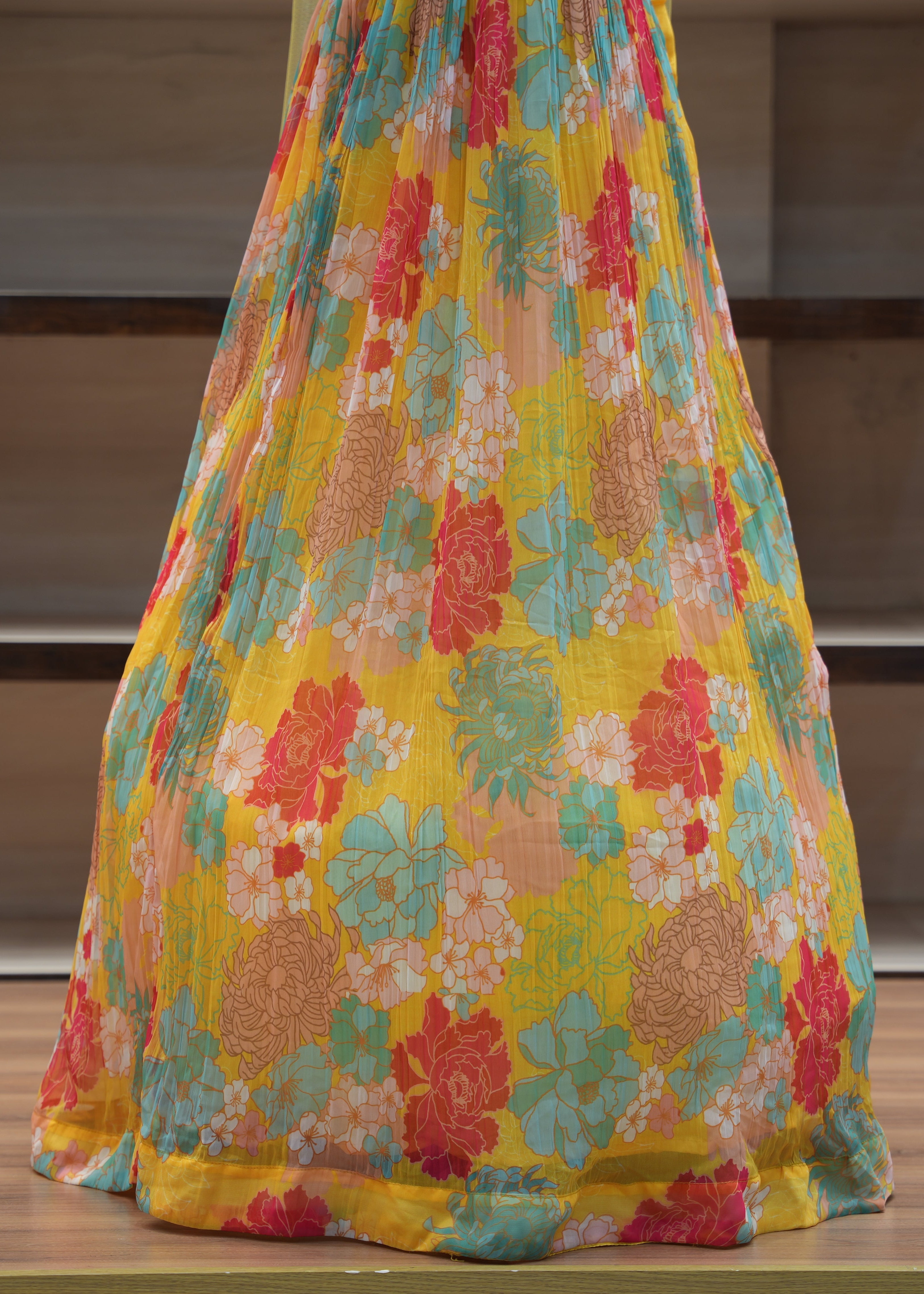 Colorful floral dress on a wooden surface with a neutral background