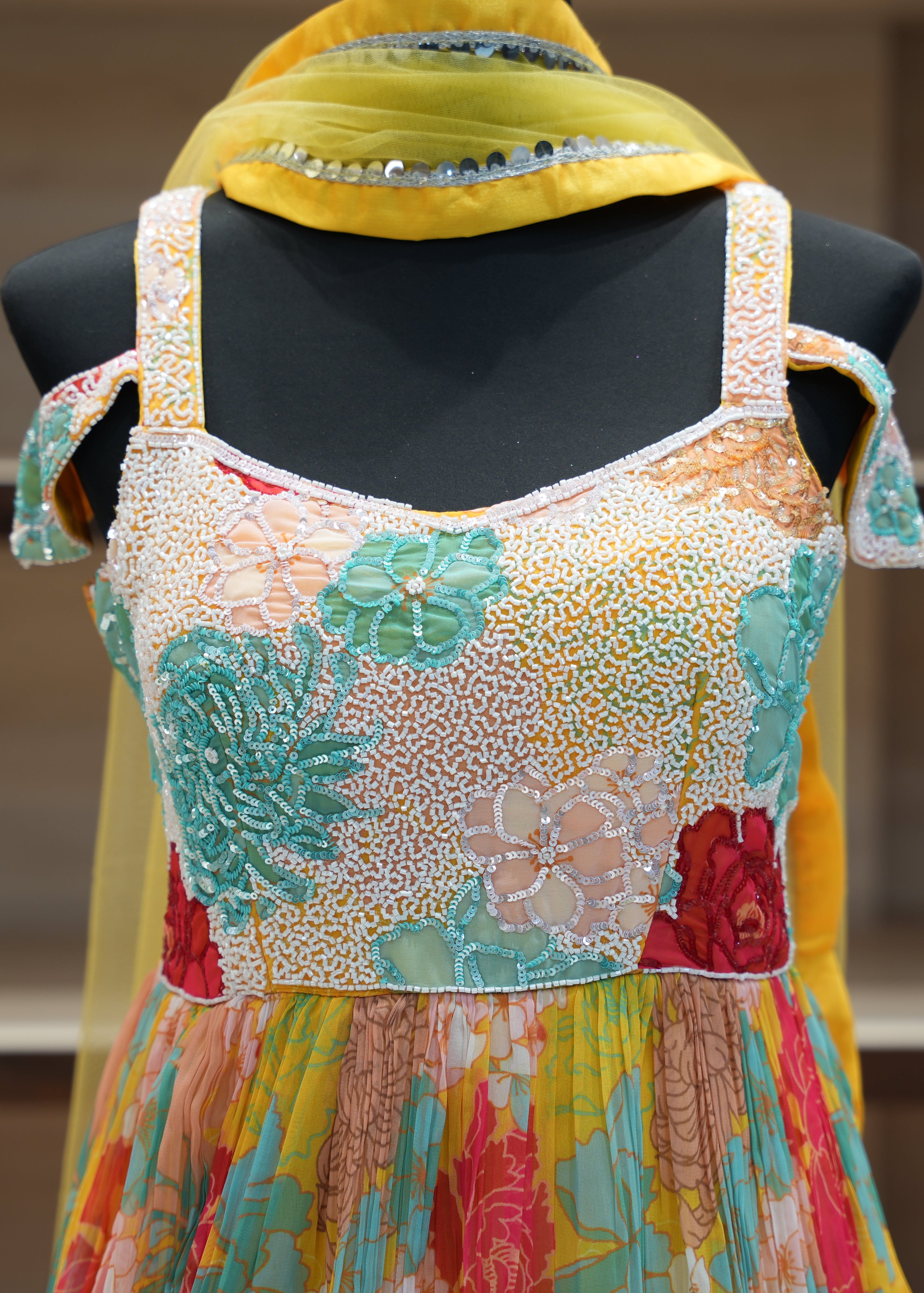 Colorful embroidered dress on a mannequin with a blurred background