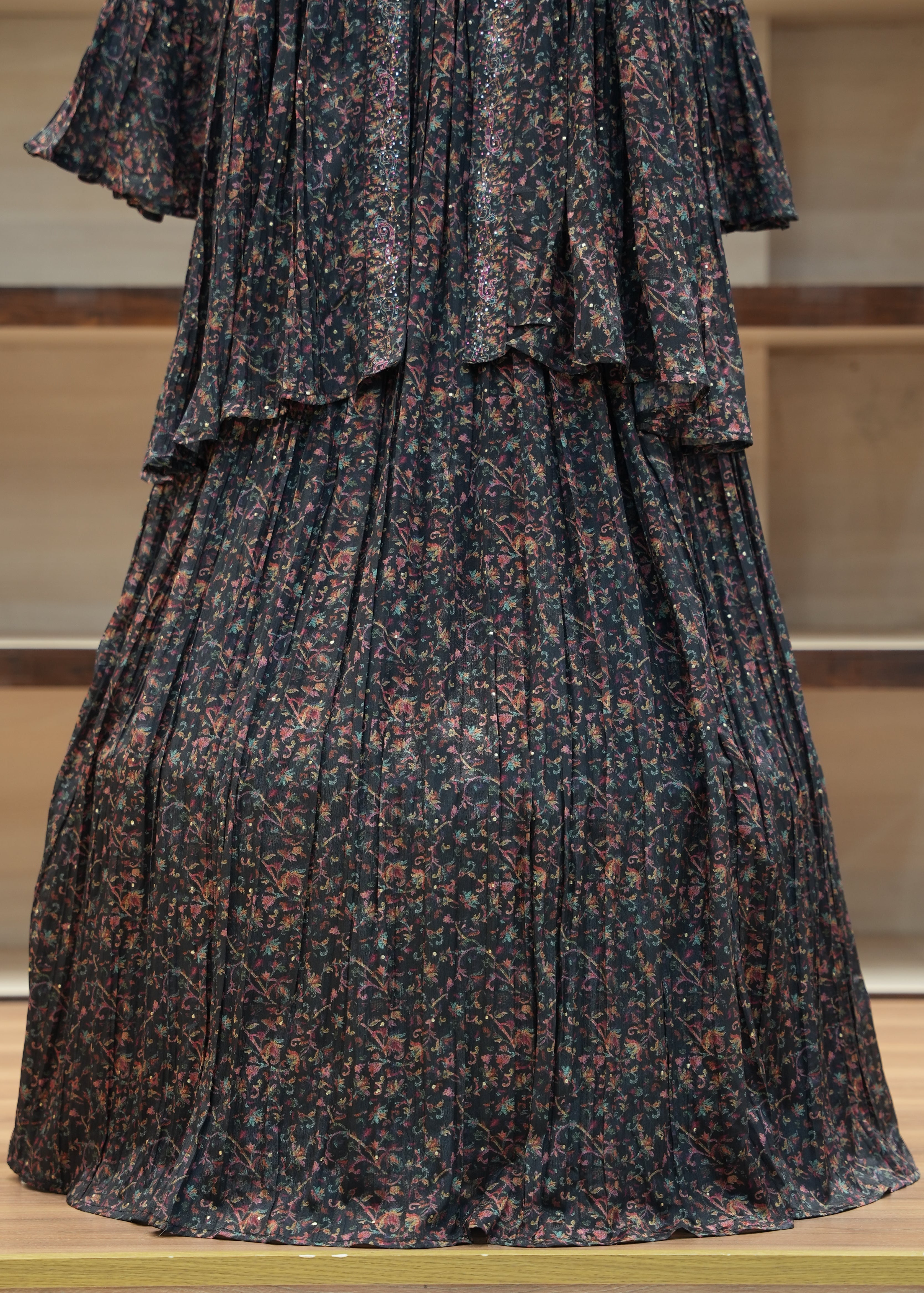 Dark patterned pleated skirt on a mannequin against a neutral background