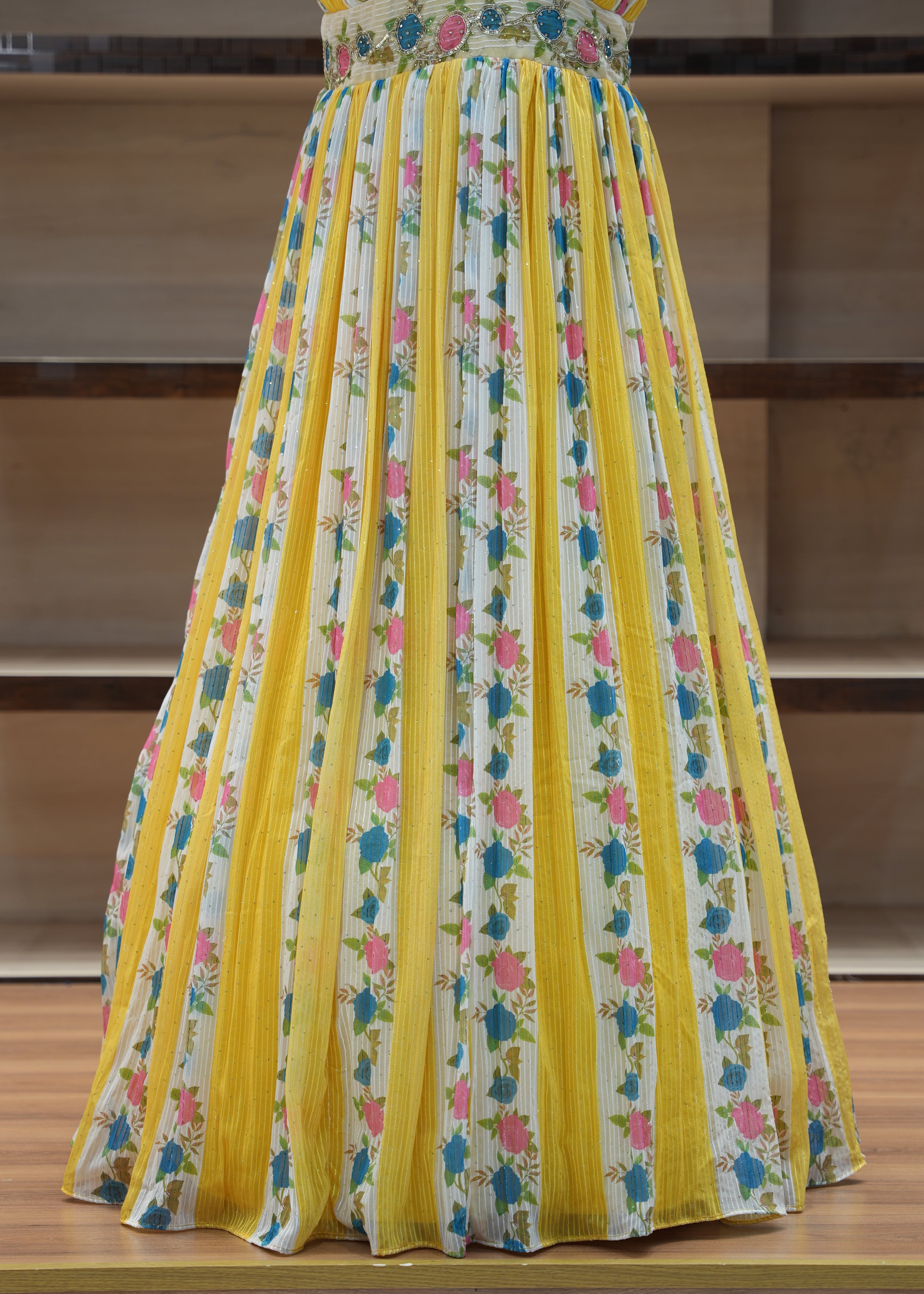 Stack of colorful fabric sheets with floral pattern on a wooden surface