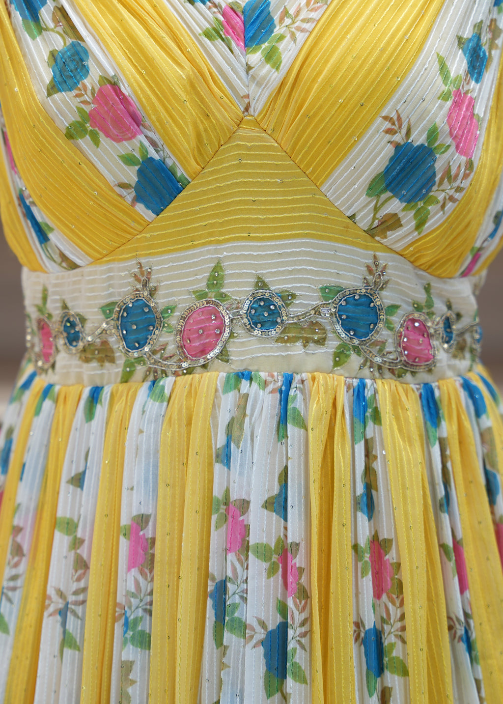 Colorful floral dress with yellow accents on a blurred background
