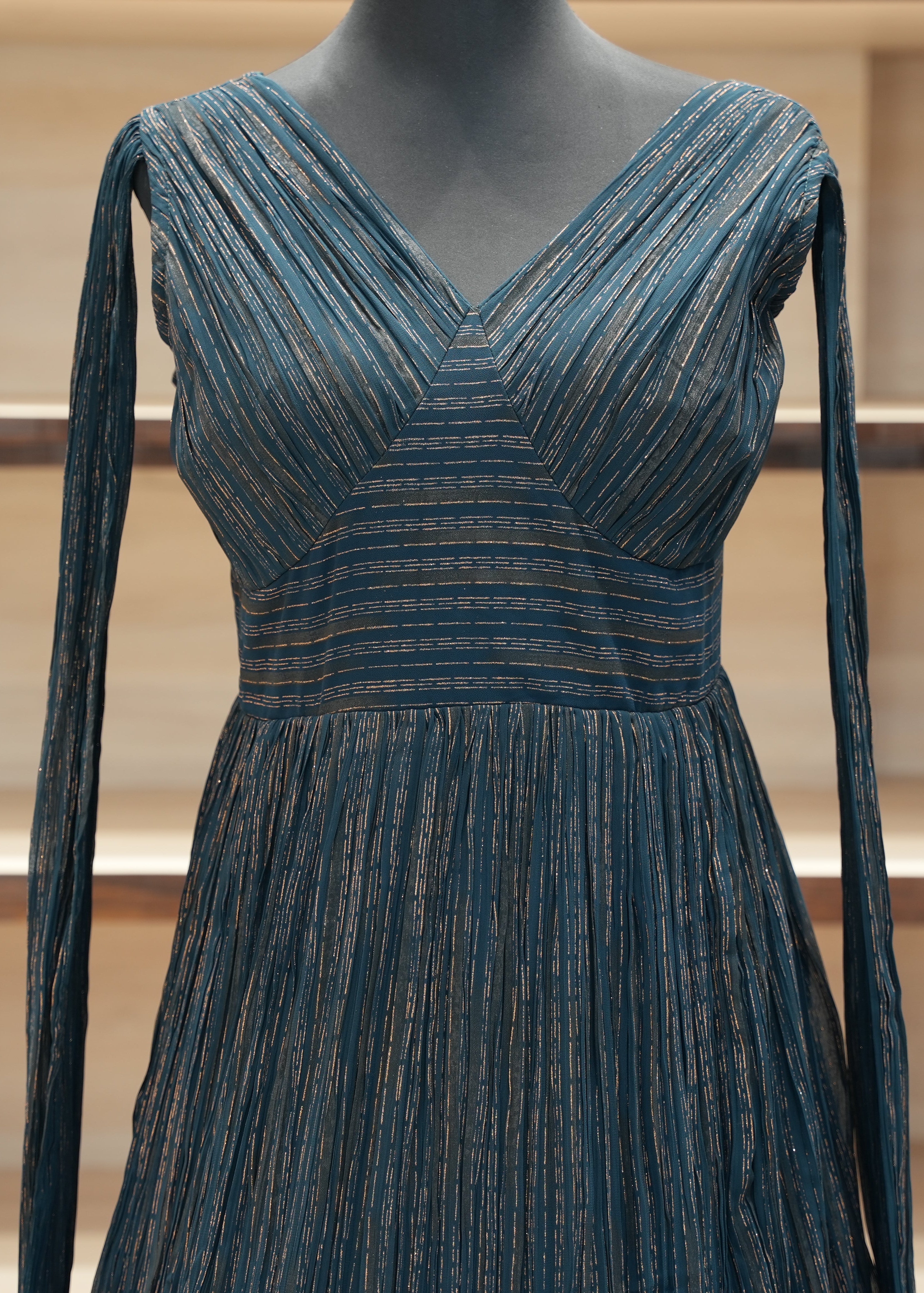 Blue dress on a mannequin against a neutral background