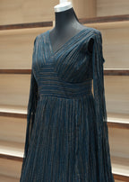 Blue textured dress on a mannequin against a neutral background