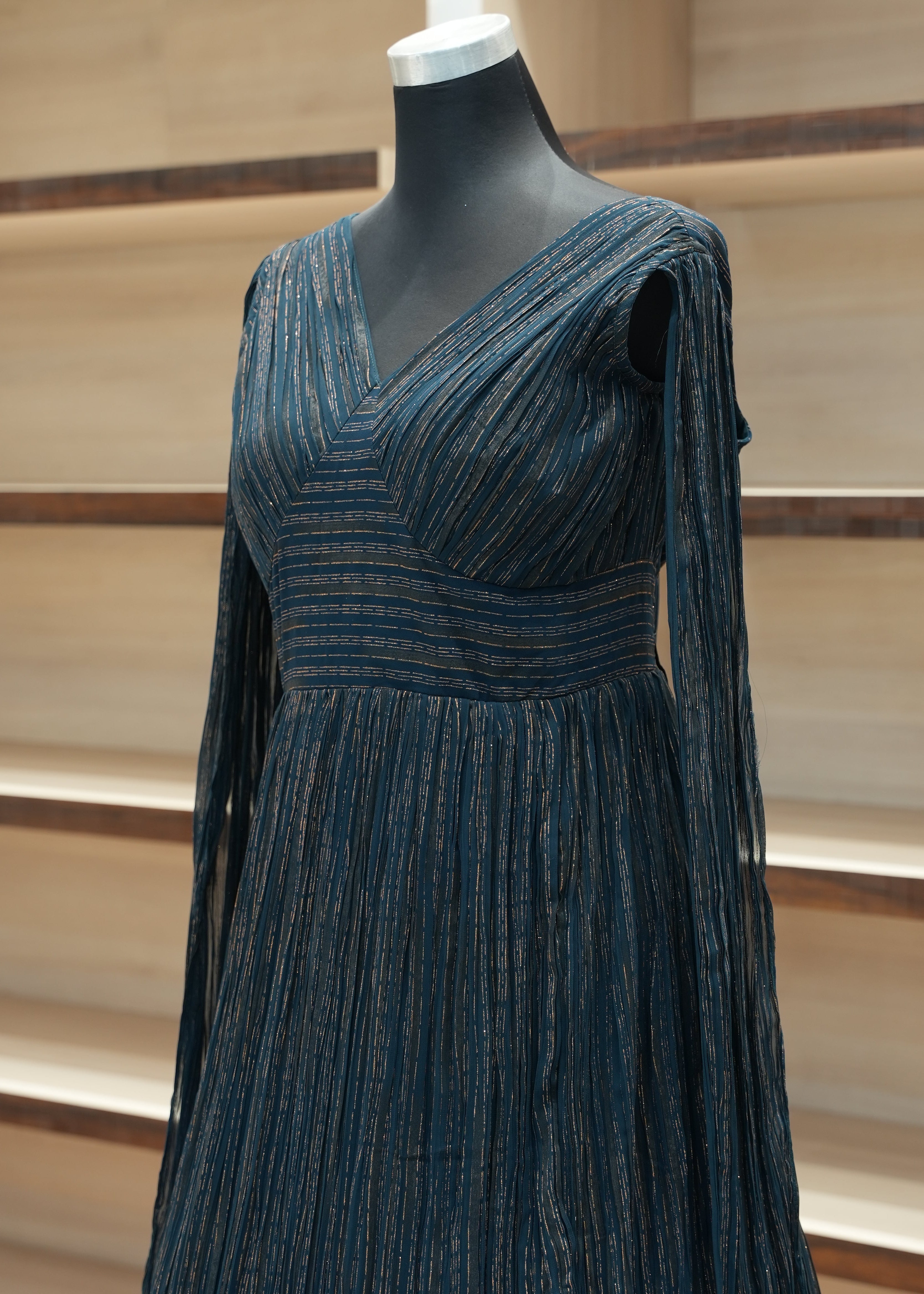 Blue textured dress on a mannequin against a neutral background