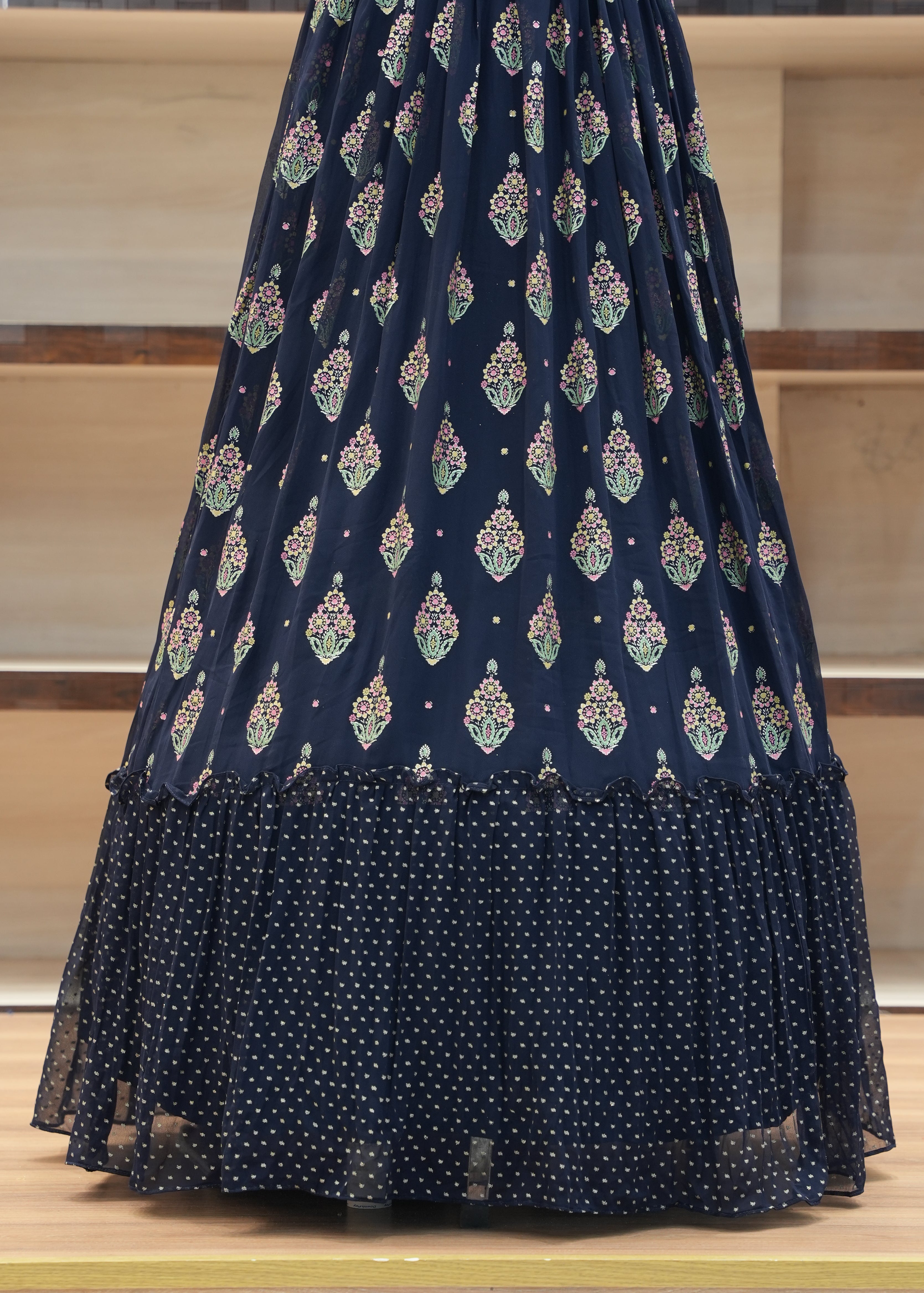 Navy blue fabric with white and green patterns draped over a chair.