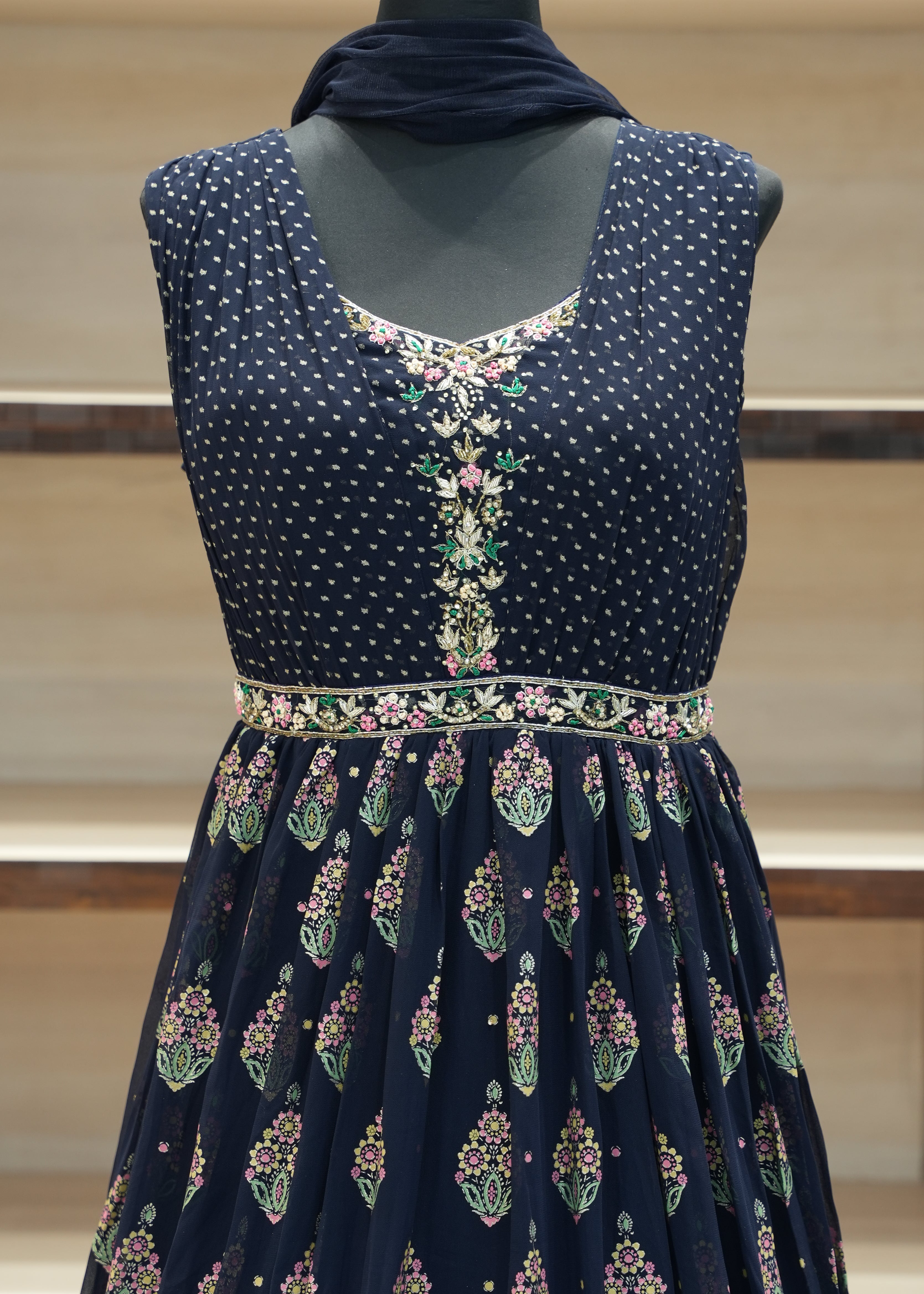 Navy blue embroidered traditional outfit on a mannequin against a neutral background