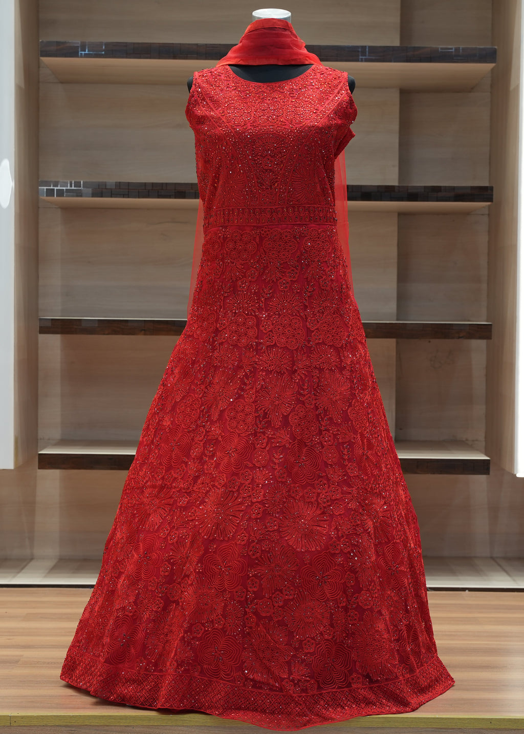 Red lace dress on a mannequin against a modern interior background