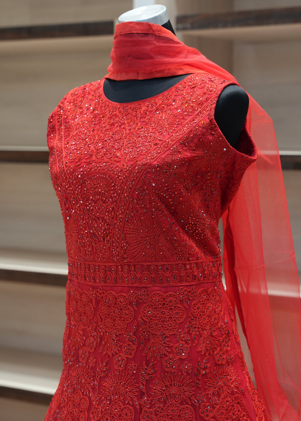 Red dress on a mannequin against a neutral background