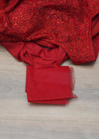 Red sequined top on a wooden surface