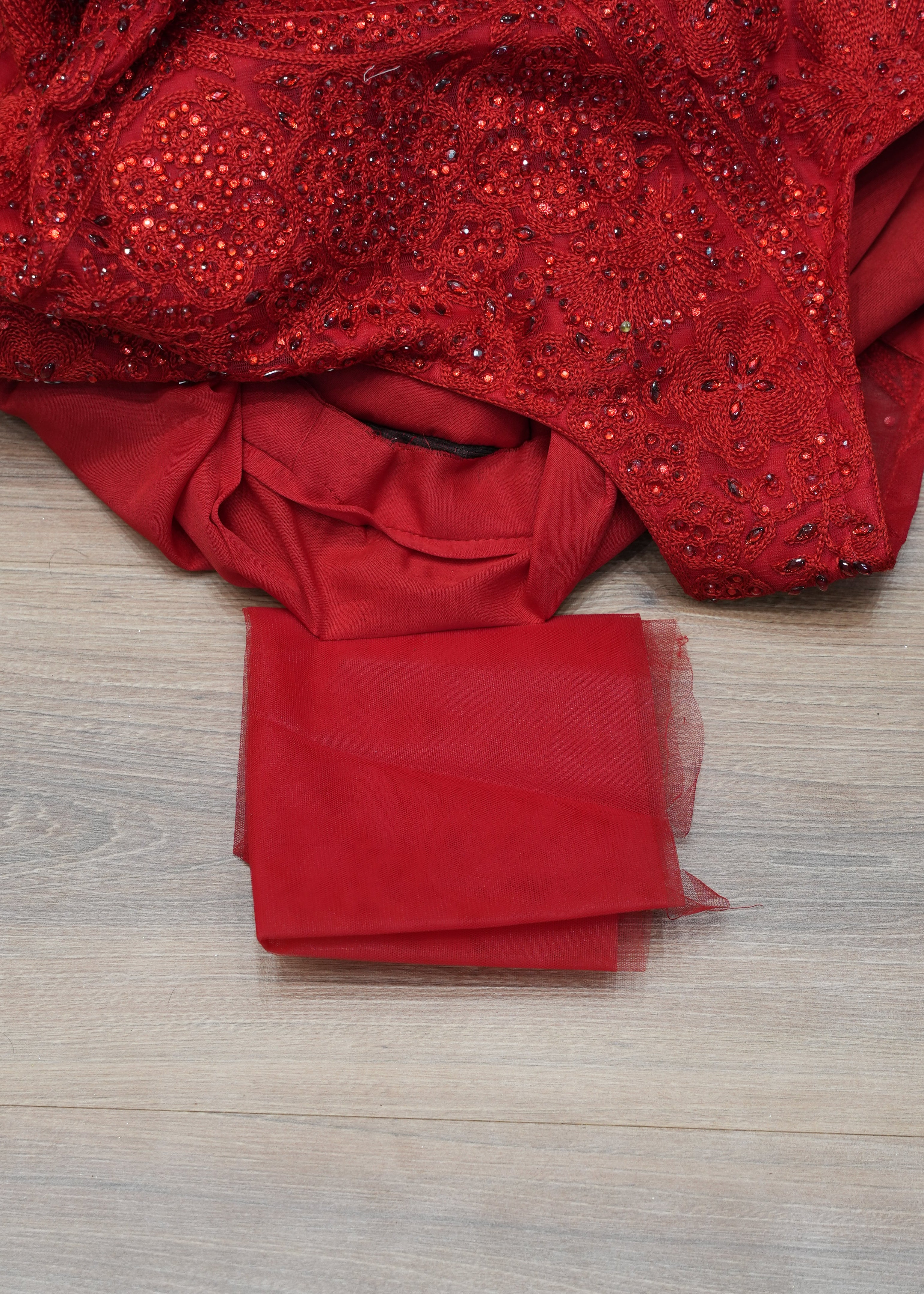 Red sequined top on a wooden surface