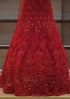 Red embroidered fabric draped over a chair with a blurred background
