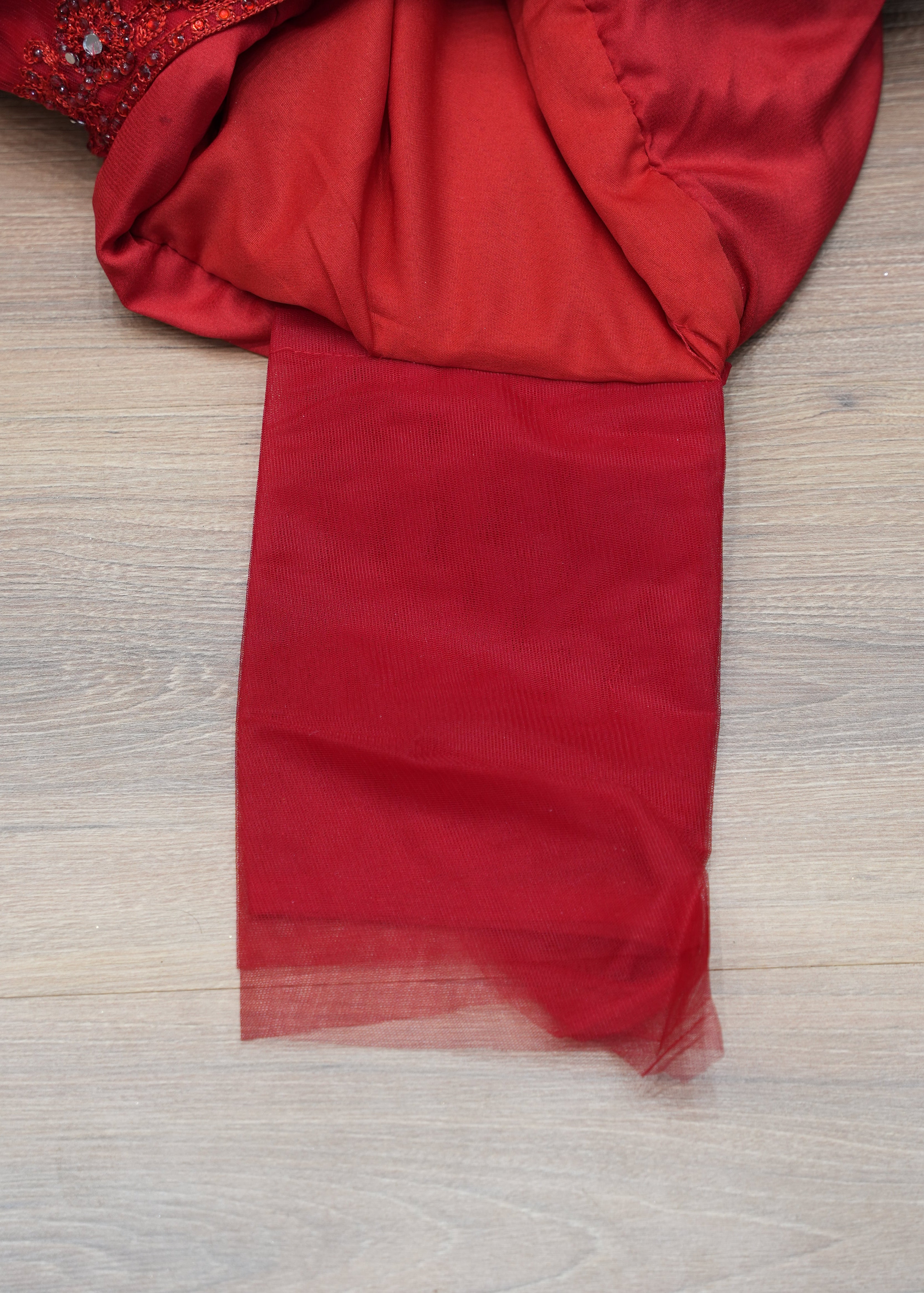 Red fabric on a wooden surface