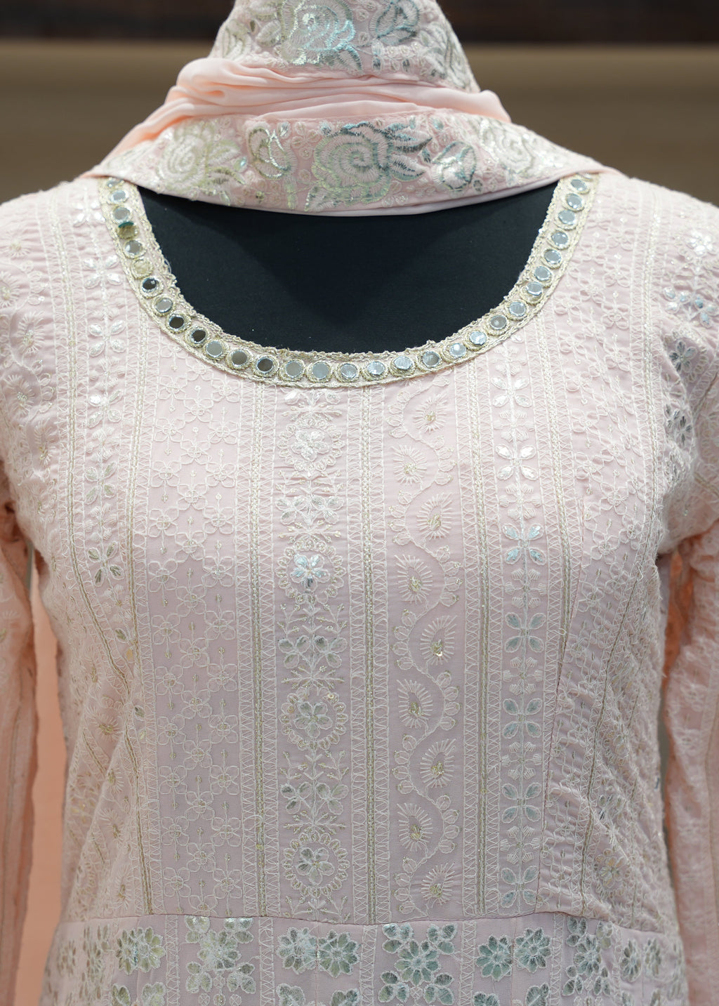 Light pink embroidered traditional outfit with a matching dupatta on a neutral background