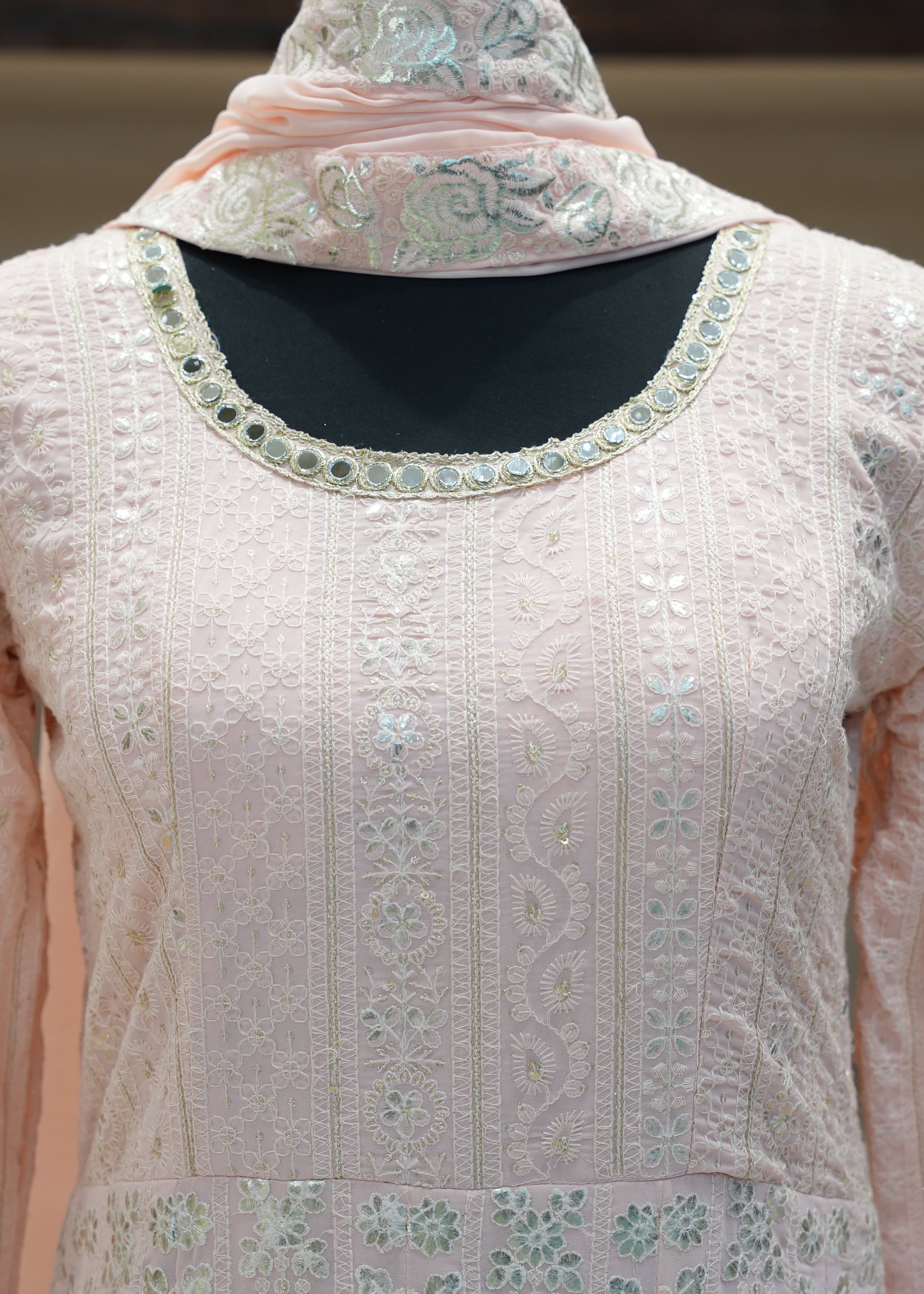 Light pink embroidered traditional outfit with a matching dupatta on a neutral background