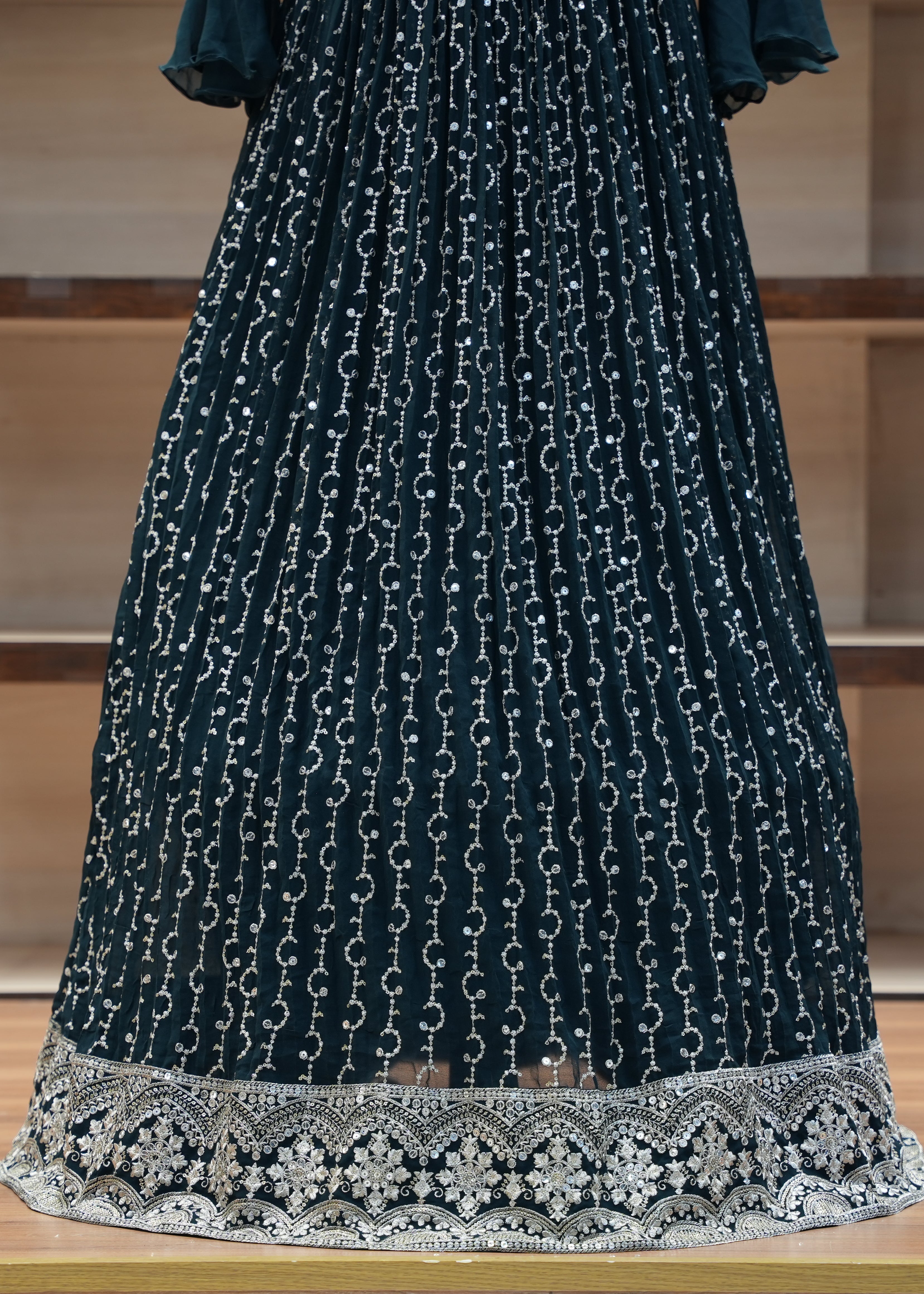 Dark blue dress with white chain pattern on a wooden surface