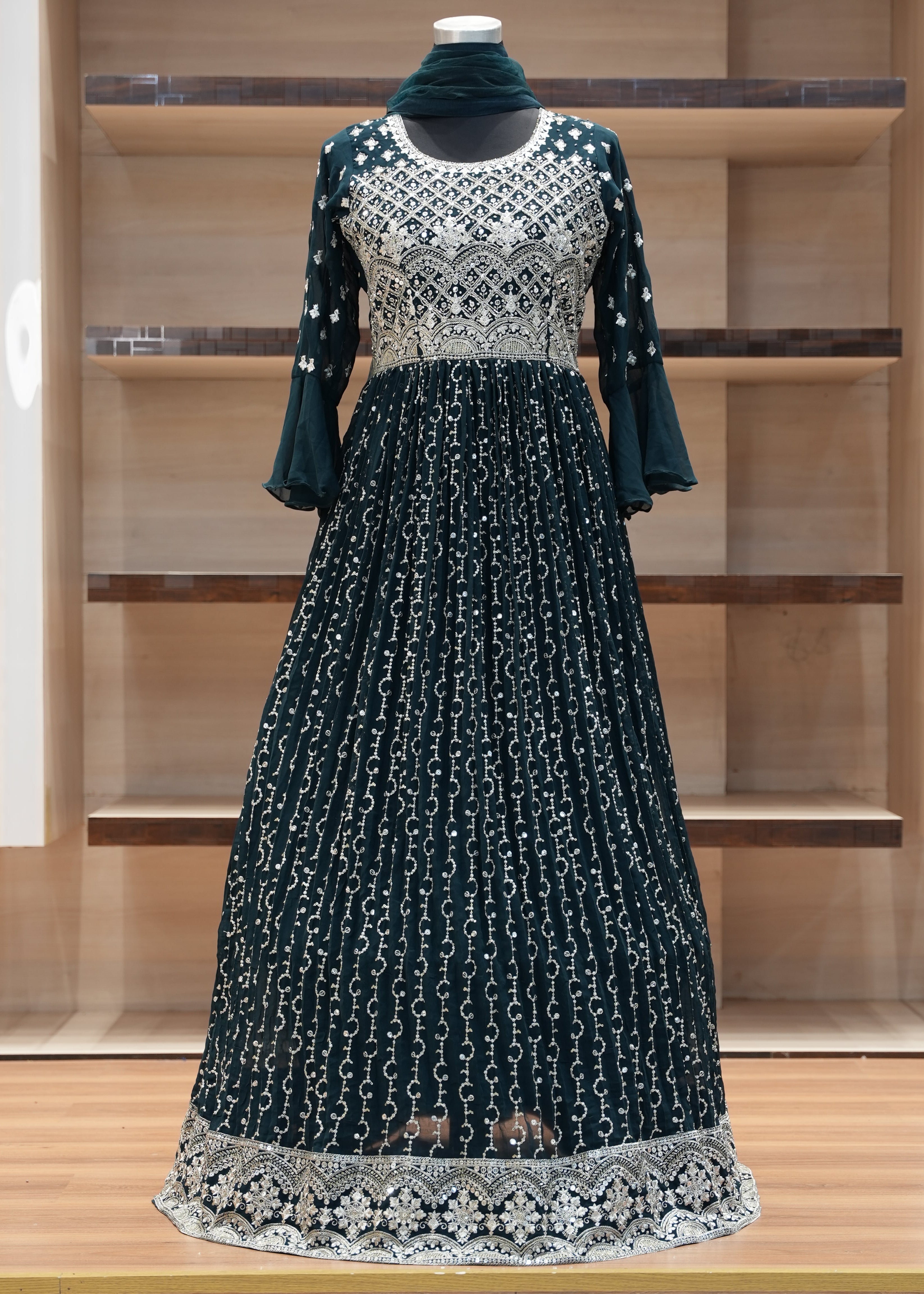 Dark blue dress with white lace details on a wooden rack.