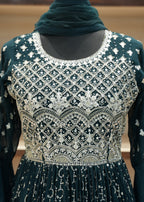 Dark green embroidered dress with a matching scarf on a neutral background