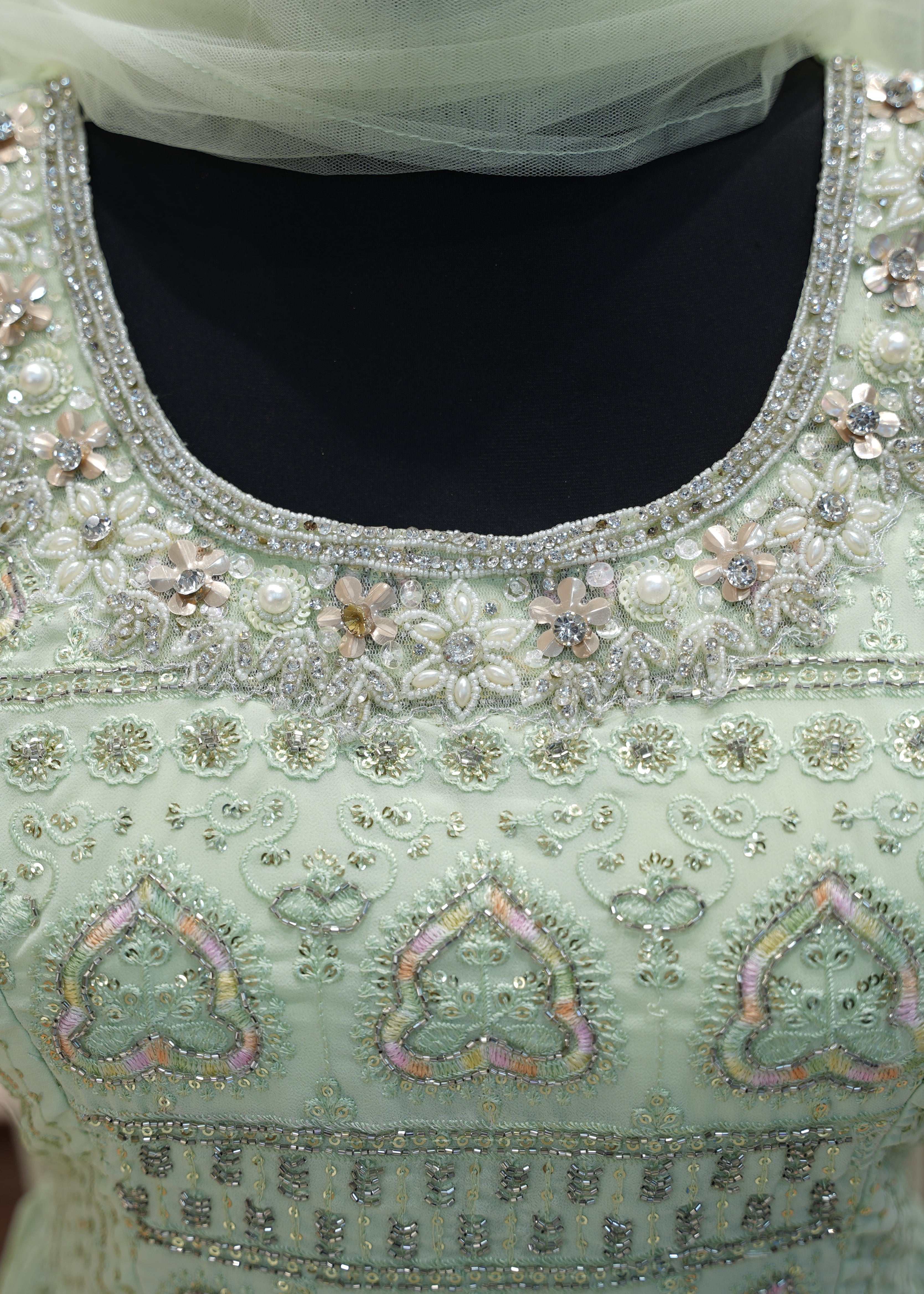 Decorative blouse with intricate beadwork on a mannequin