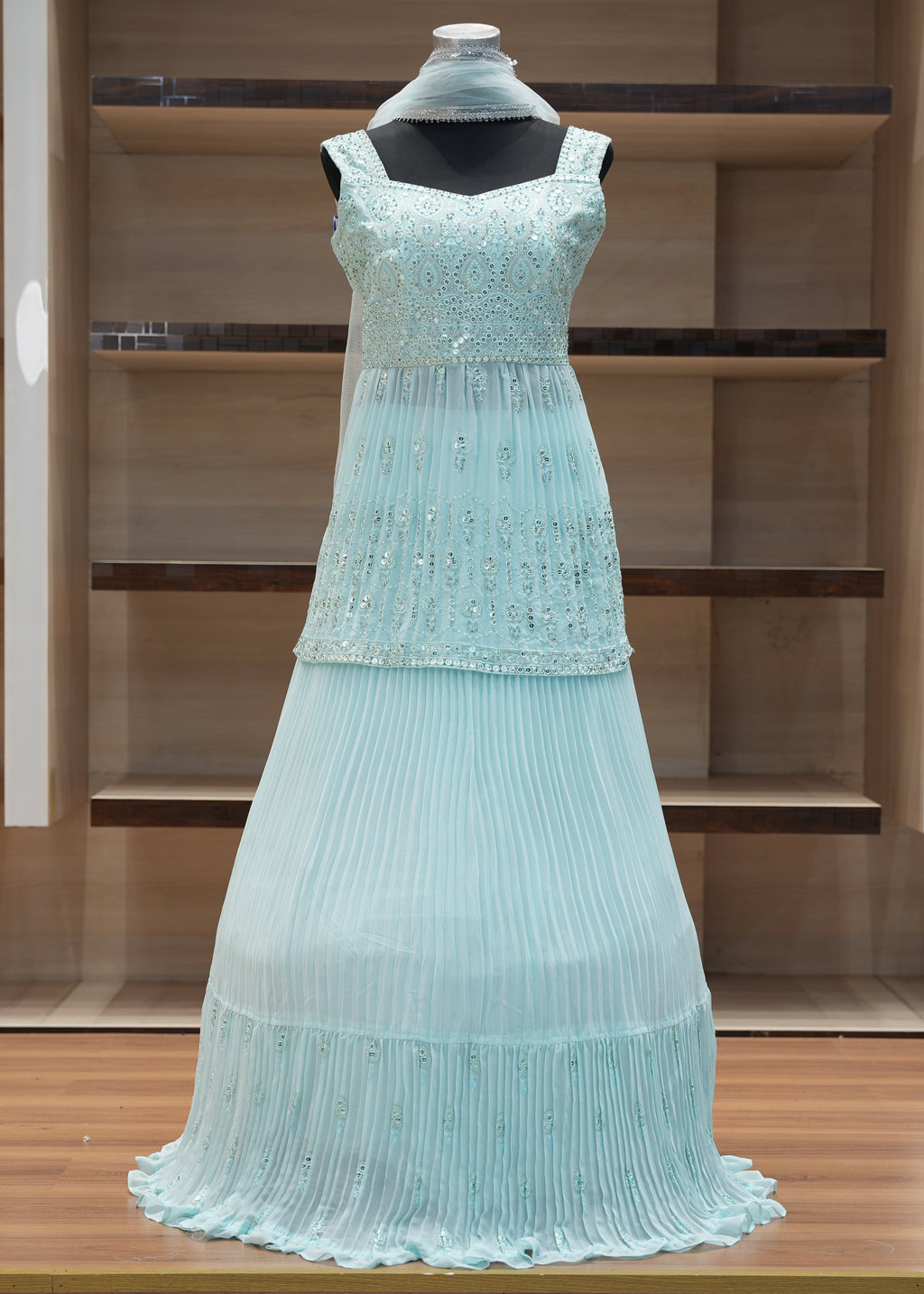 Light blue evening gown on a mannequin against a wooden background