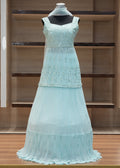 Light blue evening gown on a mannequin against a wooden background