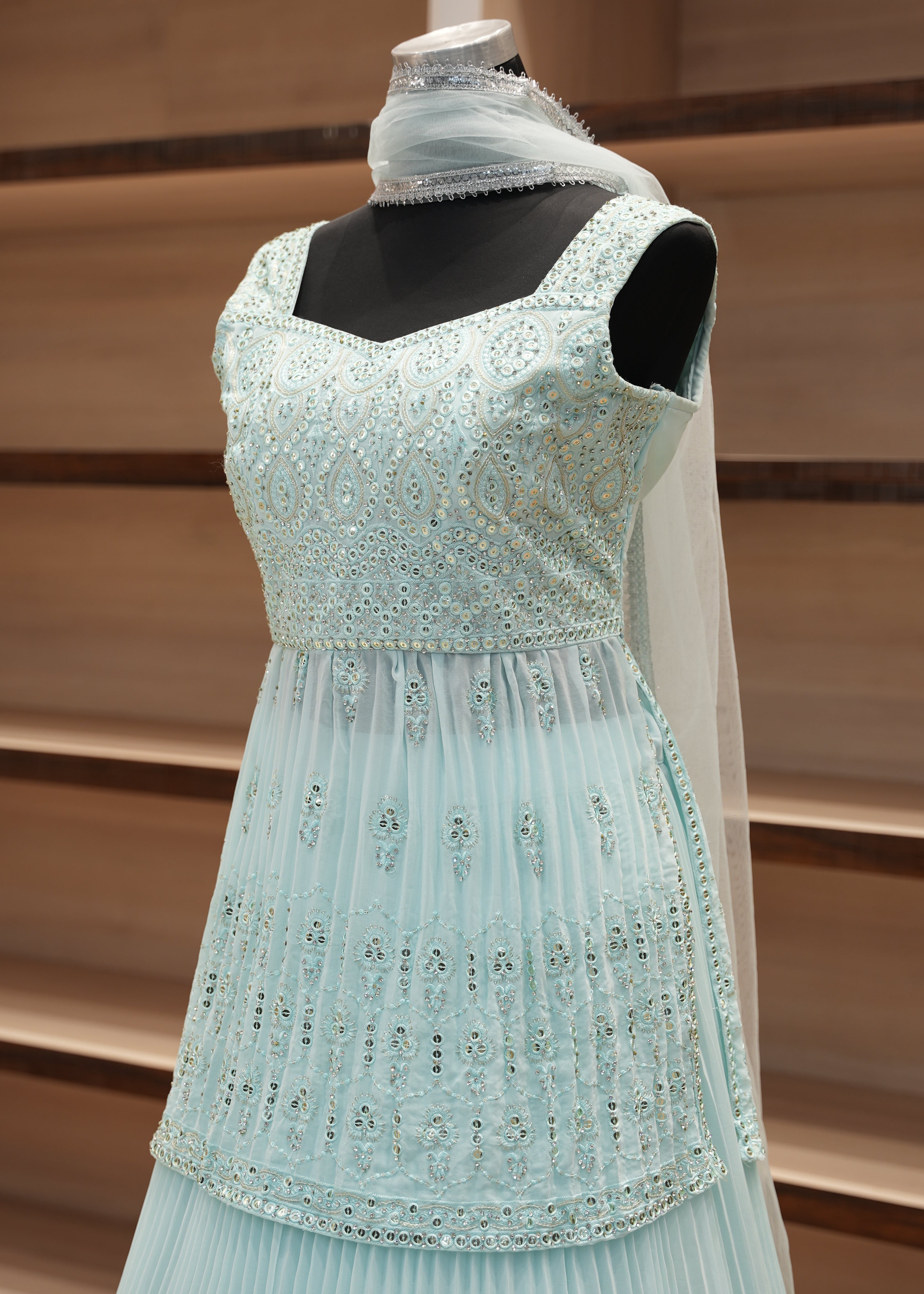 Light blue dress with black accents on a wooden surface