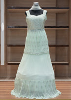 Light green dress on a mannequin against a wooden background