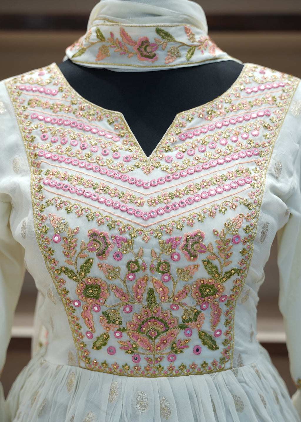 White embroidered blouse with floral patterns on a blurred background